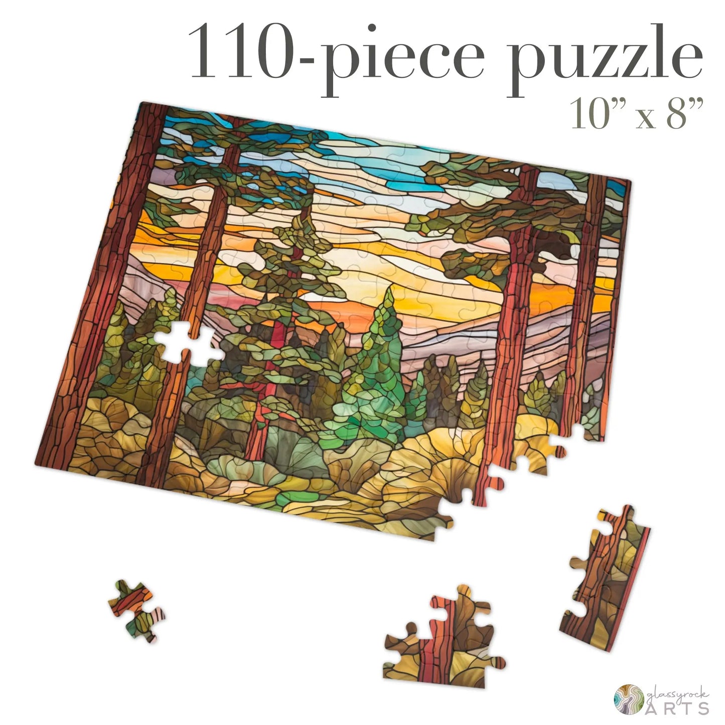 The Stained Glass Sequoia Forest Jigsaw Puzzle features a 110-piece scene of towering trees and a sunset in stained glass style. Partially assembled with scattered pieces, it makes a perfect gift for puzzle enthusiasts. Dimensions: 10 inches by 8 inches.