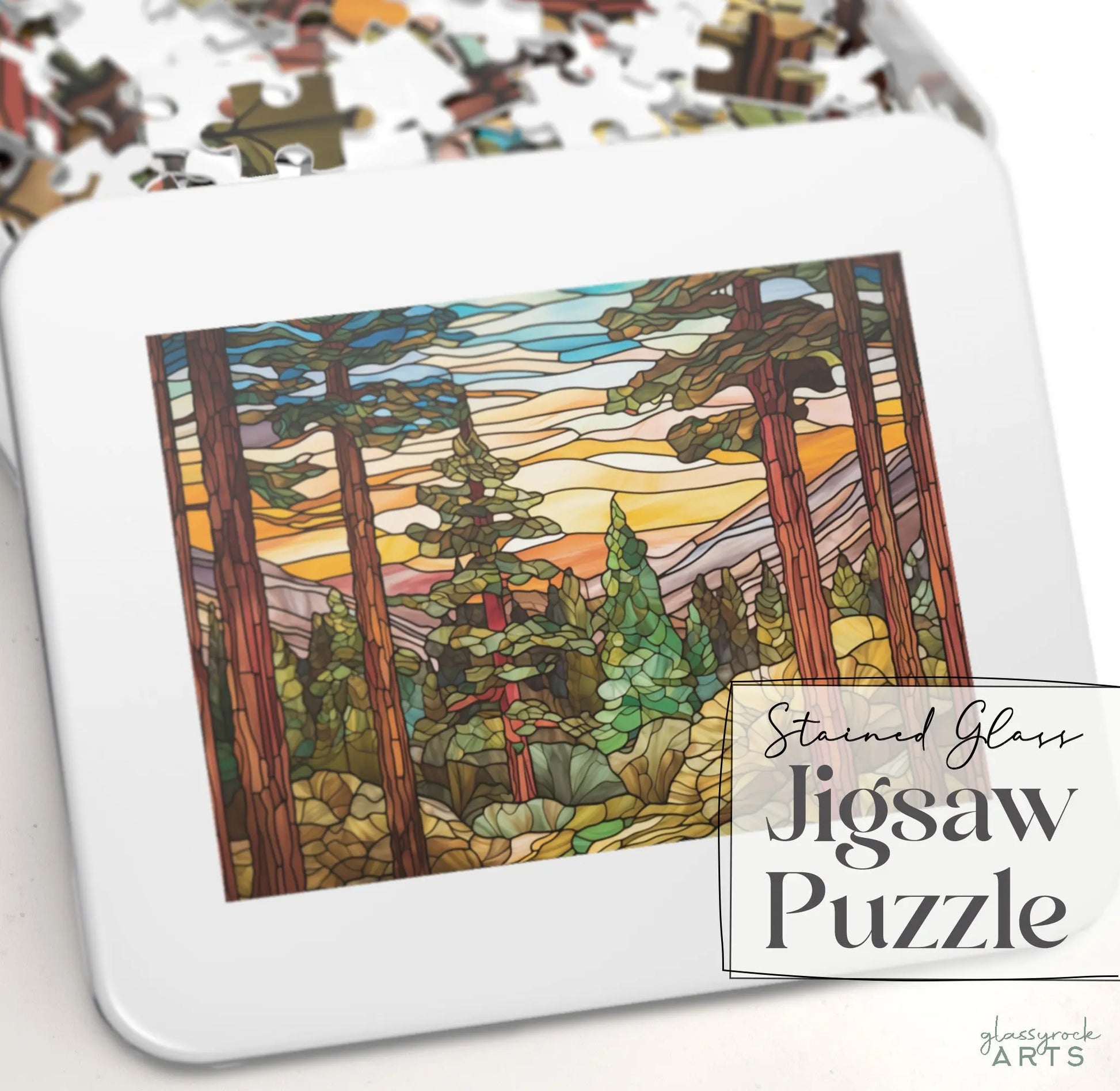 The Stained Glass Sequoia Forest Jigsaw Puzzle by Glassrack Arts features a scenic forest with tall trees under a vibrant sky. The pieces come in a gift-ready metal box labeled Stained Glass Jigsaw Puzzle.