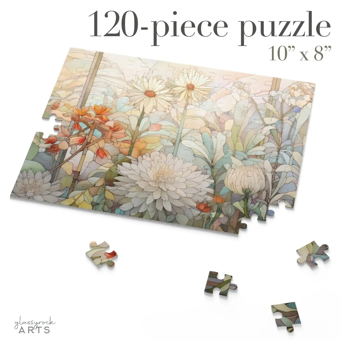 A partially completed Spring Botanicals Jigsaw Puzzle with daisies and pastel flowers is surrounded by loose pieces. This 120-piece, 10” x 8” puzzle makes a perfect floral gift for mom. Logo: glassrock ARTS.
