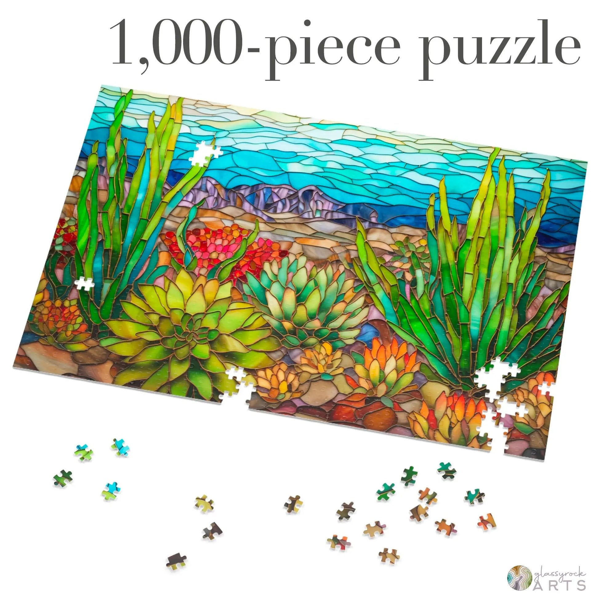 The Stained Glass Succulents Jigsaw Puzzle, a partially assembled 1,000-piece set, showcases a vibrant desert landscape with cacti resembling stained glass. Several pieces are scattered nearby, promising hours of entertainment for enthusiasts or serving as an ideal gift-ready challenge.