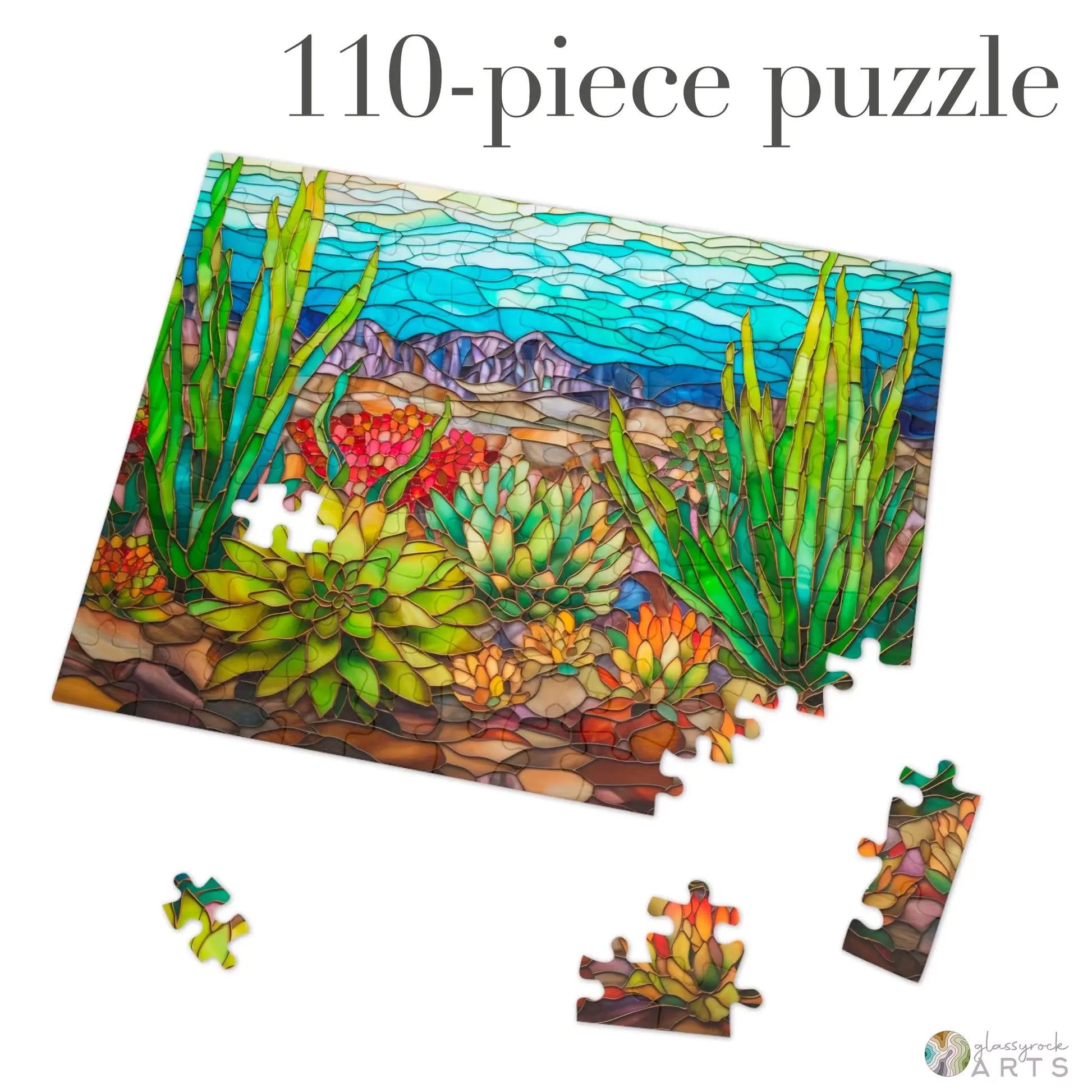 The Stained Glass Succulents Jigsaw Puzzle, a 110-piece set, features a vibrant desert landscape with mosaic-style succulents and cacti. Scattered puzzle pieces make it gift-ready for any enthusiast.