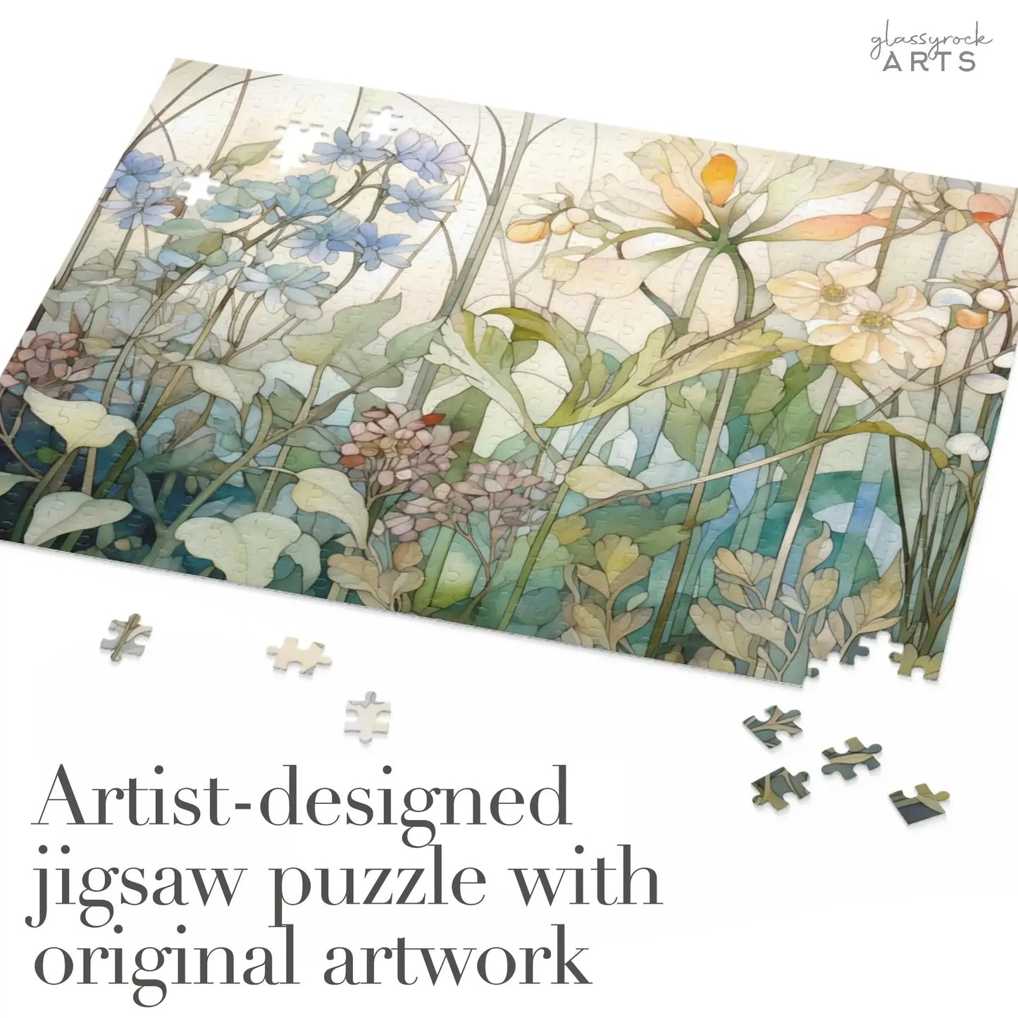 A partially completed Summer Wildflowers Jigsaw Puzzle showcases floral artwork of wildflowers and stems, with several pieces scattered nearby. Text in the corner reads, Artist-designed puzzle with original artwork.