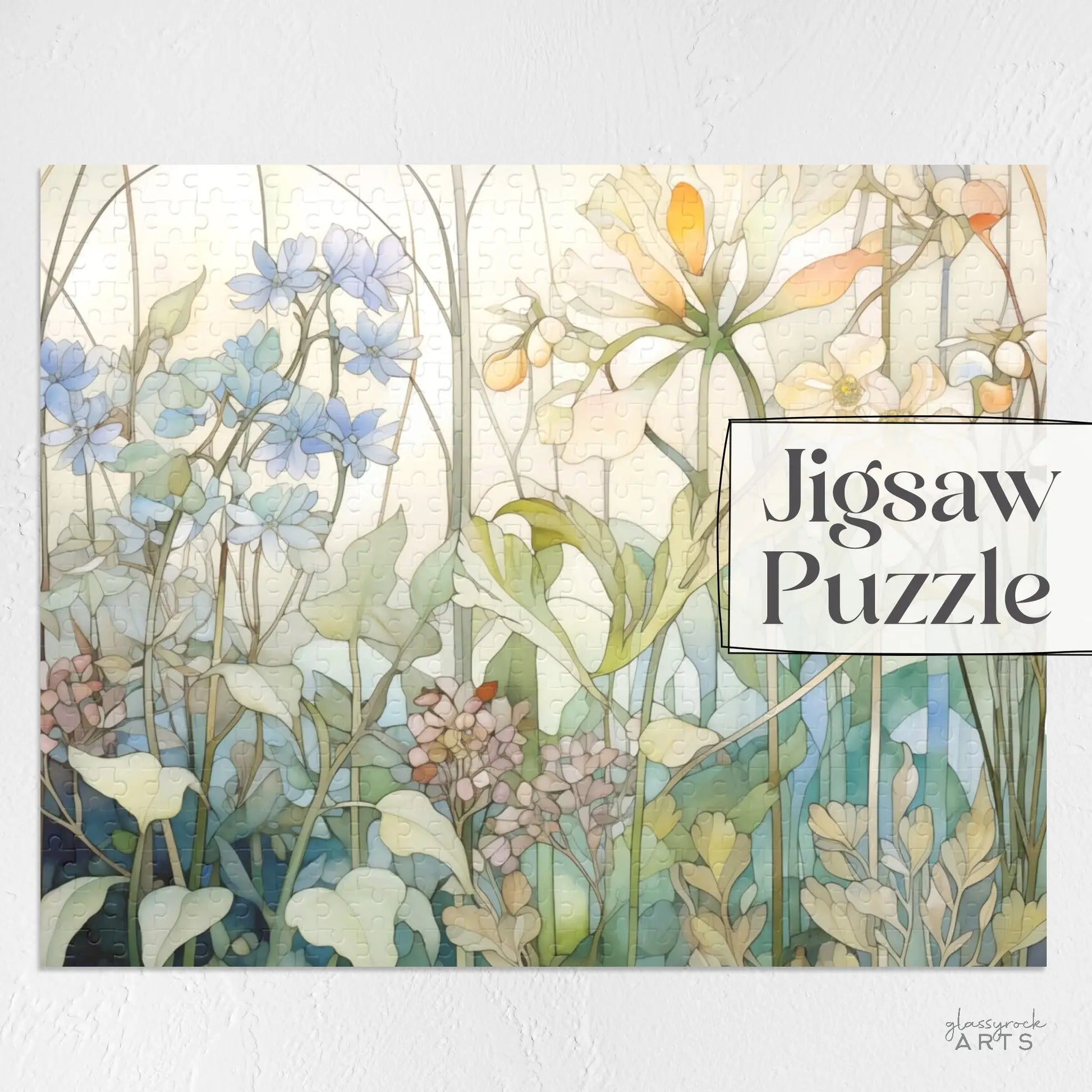 The Summer Wildflowers Jigsaw Puzzle features a watercolor illustration of vibrant summer wildflowers in soft pastel hues of blue, green, and yellow, with Jigsaw Puzzle text on the upper right.