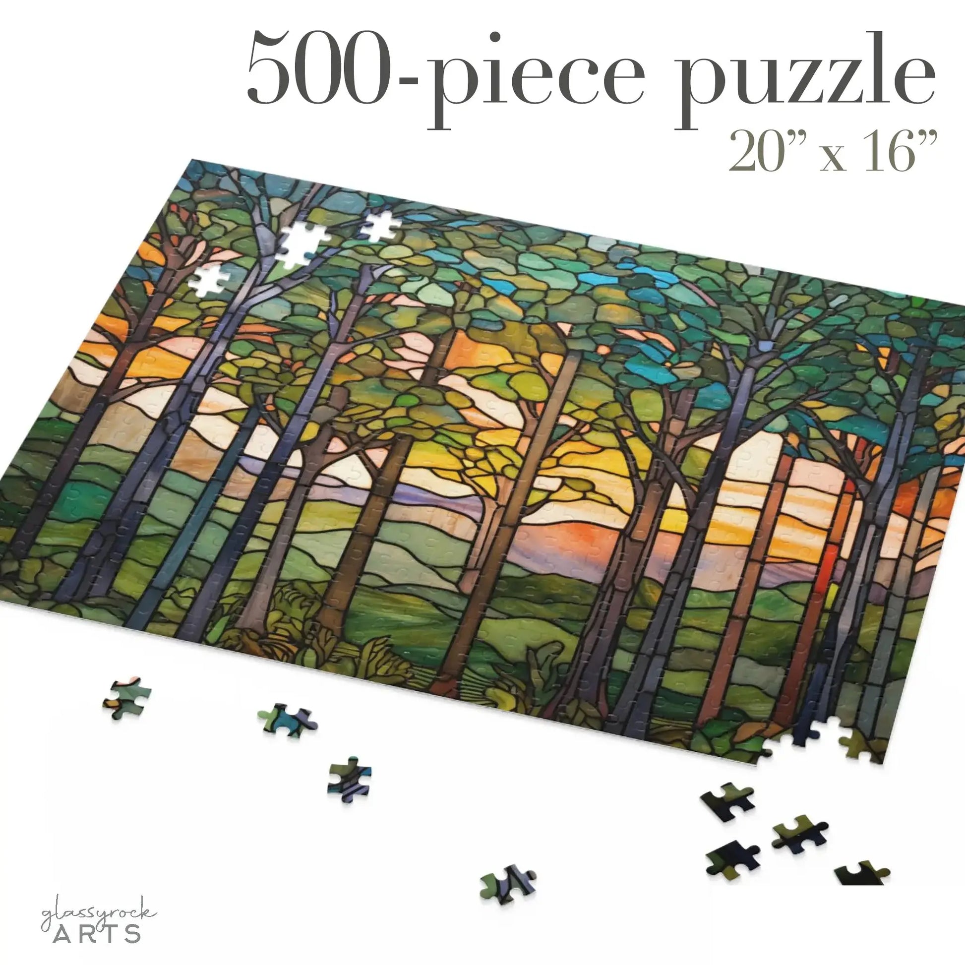 The Sunset Forest Jigsaw Puzzle features 500 pieces forming a stunning scene of tall trees silhouetted against a stained glass-like sunset sky. Ideal for nature lovers, it measures 20 x 16 and comes with an image showing the puzzle partly completed with scattered loose pieces.