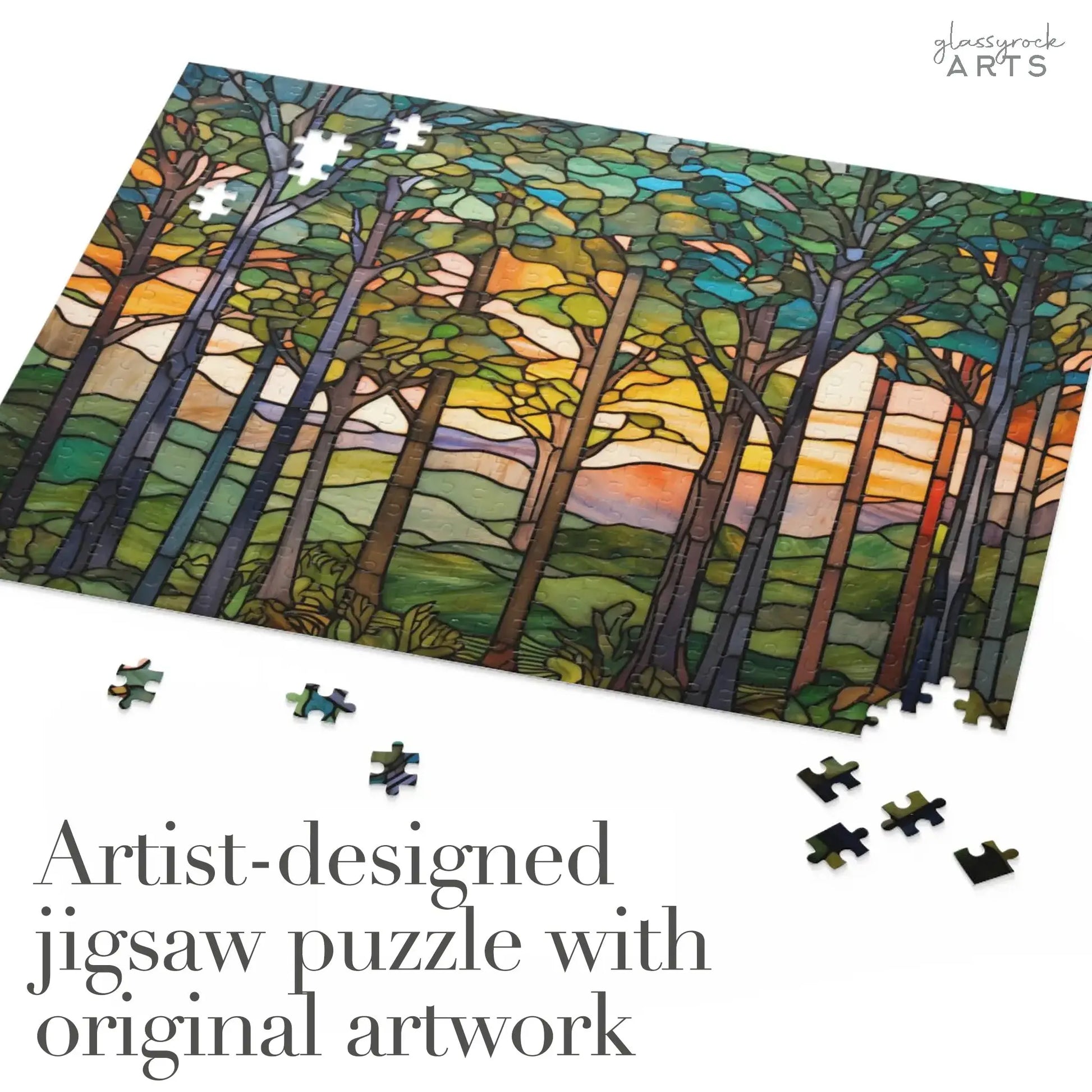 The Sunset Forest Jigsaw Puzzle displays vibrant artwork of a colorful sky, with scattered pieces inviting engagement. The text states, Artist-designed jigsaw puzzle with original artwork, making it an ideal stained glass gift for nature lovers.