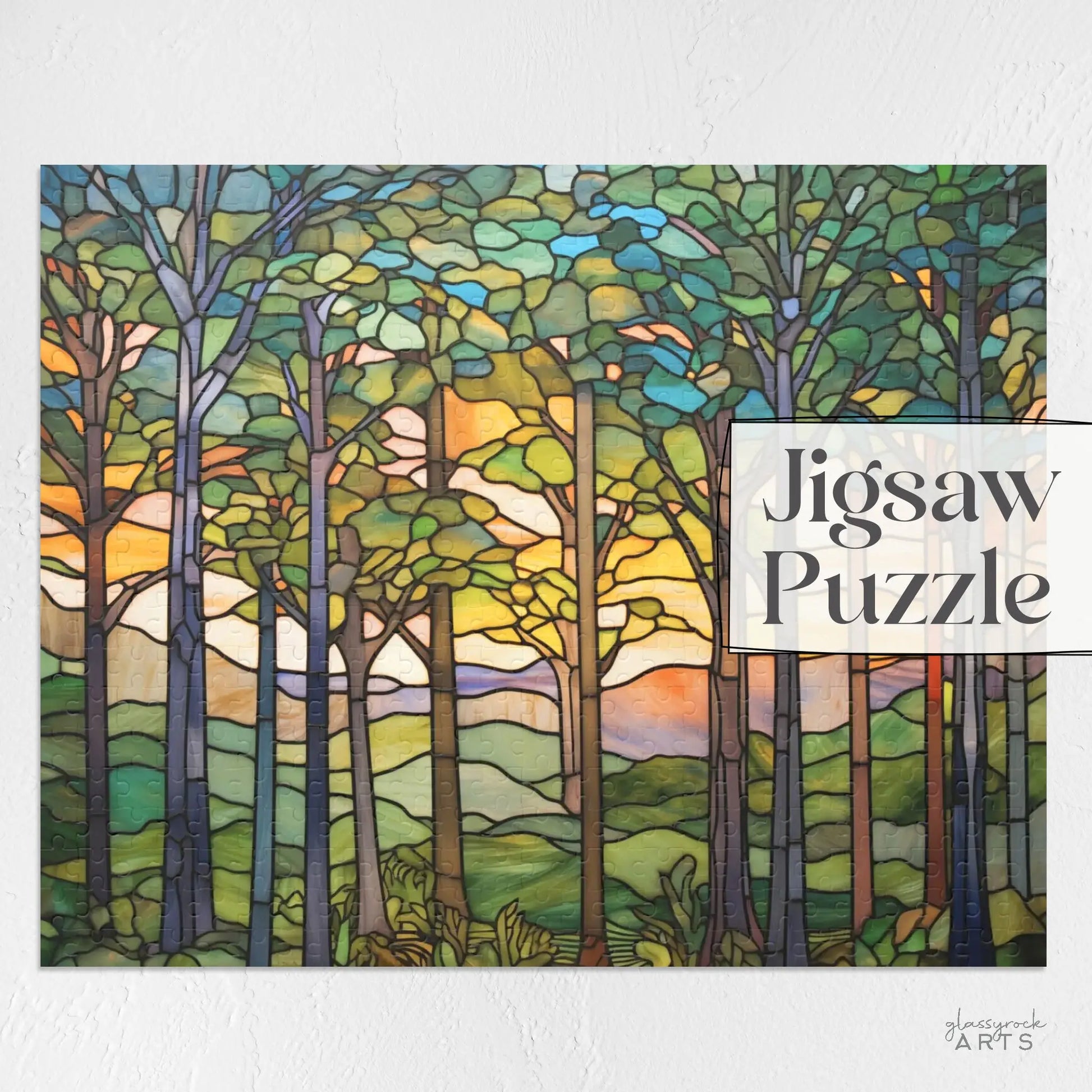 A stained glass-style artwork showing a sunset forest scene with tall trees, vibrant leaves, and a colorful sky. Its perfect for nature lovers and features the text Sunset Forest Jigsaw Puzzle on the right side.