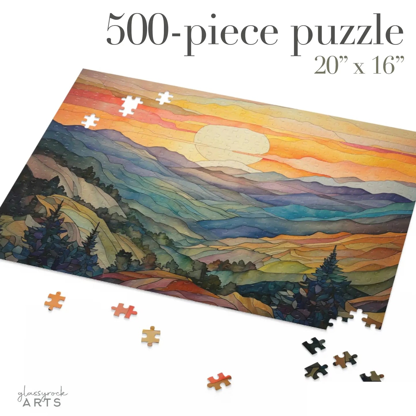 A partially completed Sunset Mountains Jigsaw Puzzle with 500 pieces, measuring 20x16, depicts a vivid landscape of sunset mountains, hills, and trees. Scattered pieces surround the main image. Ideal for nature enthusiasts, the title 500-piece puzzle 20x16 is displayed above.
