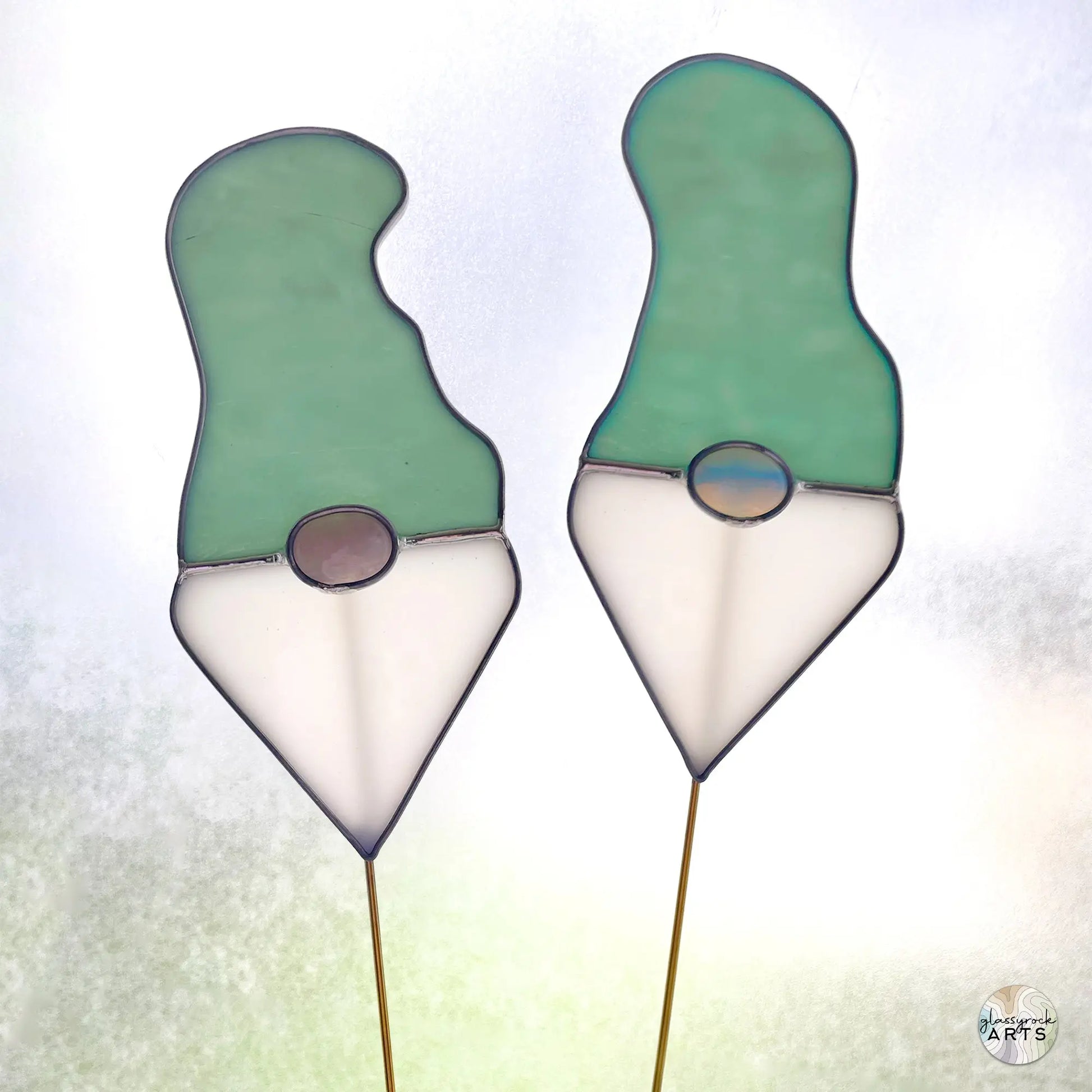 A picture of the Handmade Stained Glass Gnome Plant Stake - Teal Hat from GlassyRock Arts.