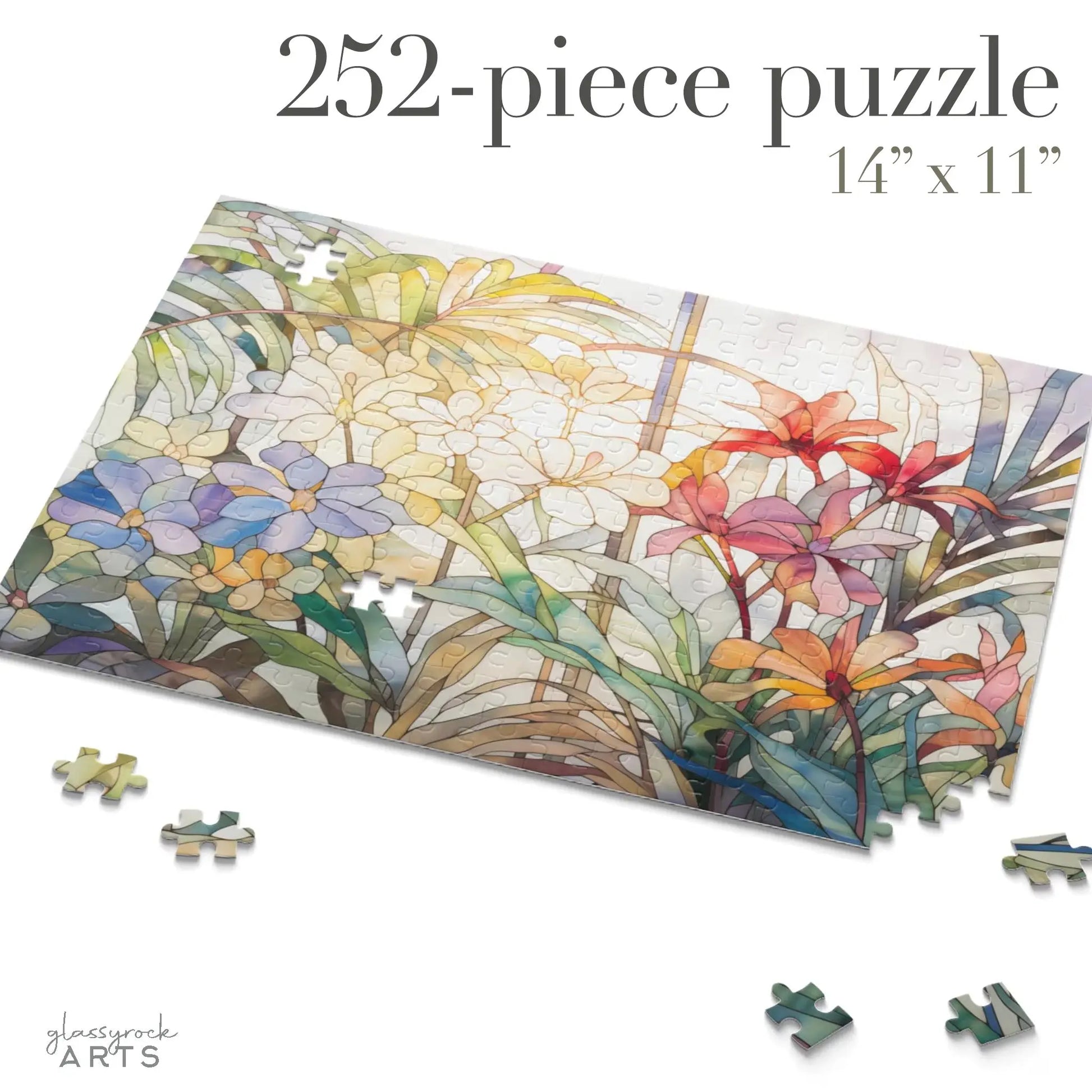 The Tropical Blooms Jigsaw Puzzle features a vibrant design of colorful flowers and foliage with 252 pieces. Measuring 14x11 inches, its an ideal art gift when partially assembled with scattered pieces. Text reads 252-piece puzzle 14 x 11.