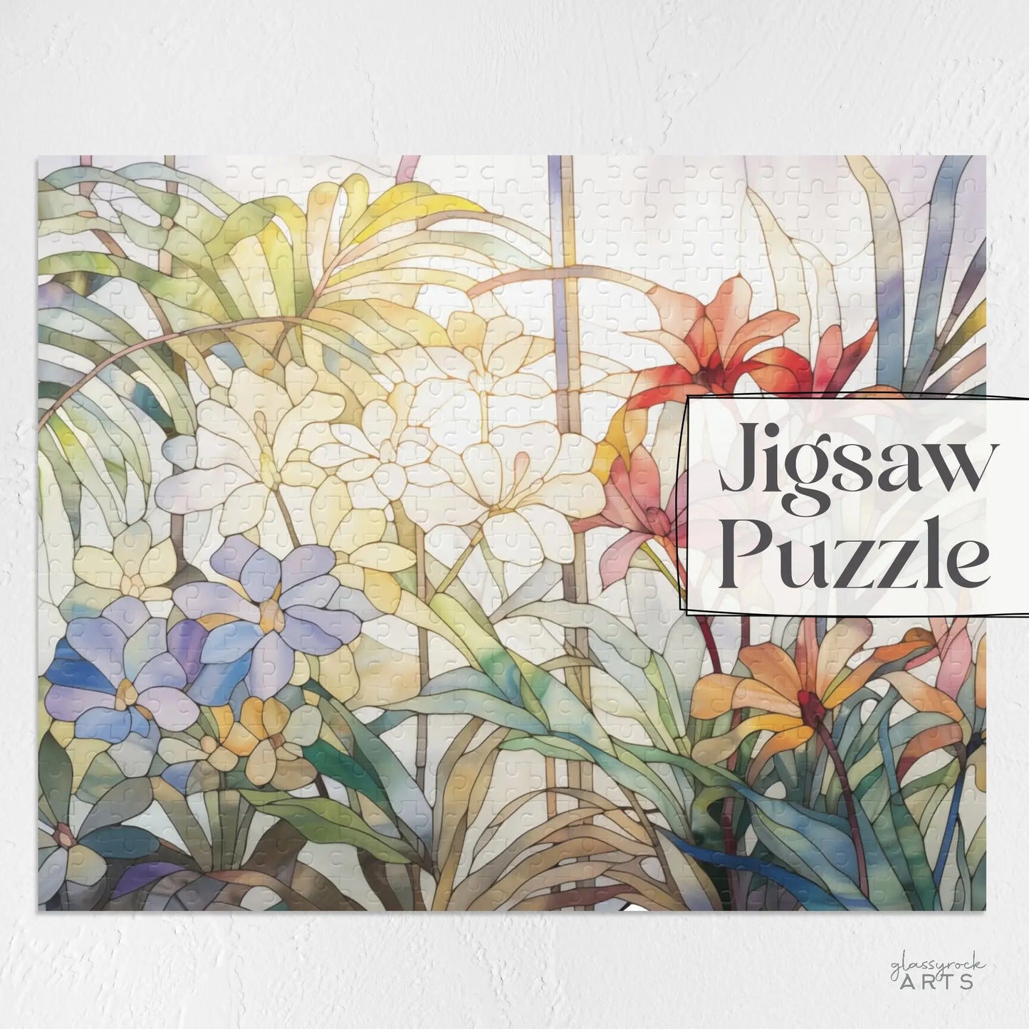 The Tropical Blooms Jigsaw Puzzle features a vibrant array of white, blue, and red flowers with lush green foliage on a light textured background. Its an ideal art gift for nature lovers who appreciate beauty. Text reads Jigsaw Puzzle.