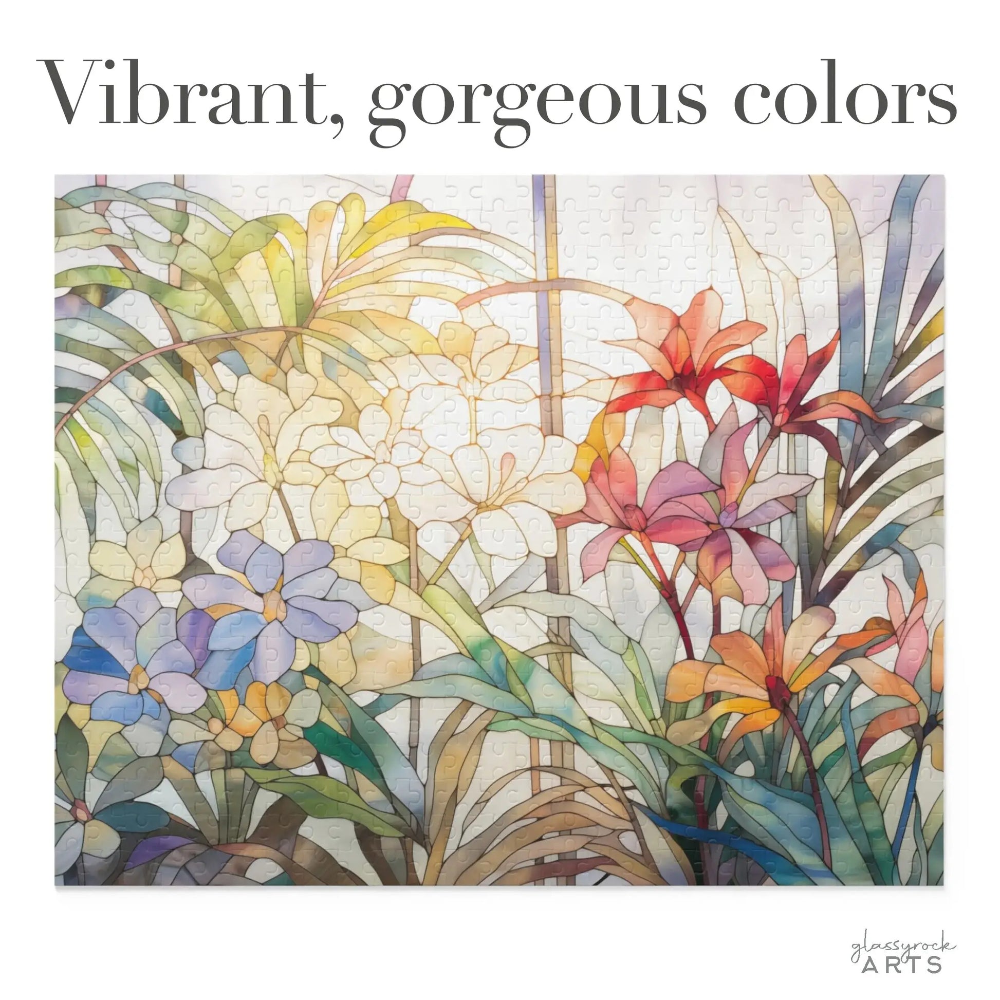 The Tropical Blooms Jigsaw Puzzle showcases vibrant floral designs with blossoms in red, blue, yellow, and green. The foliage mimics stained glass against a light backdrop, making it an exquisite art gift for any occasion.