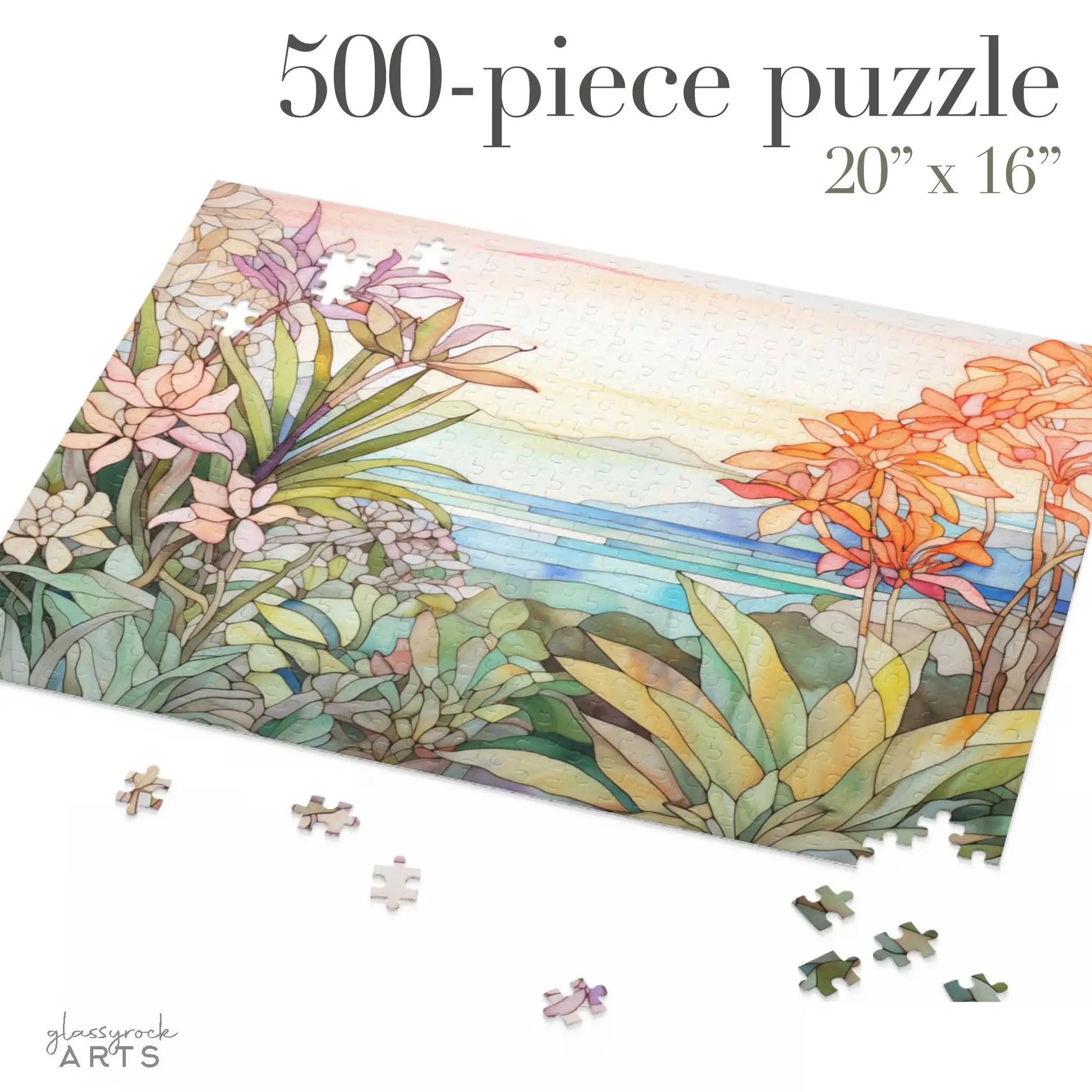 The Tropical Botanicals Jigsaw Puzzle features a stained glass-inspired design of vibrant tropical plants and a tranquil coastal scene. Loose pieces are displayed with text stating 500-piece puzzle, 20 x 16.
