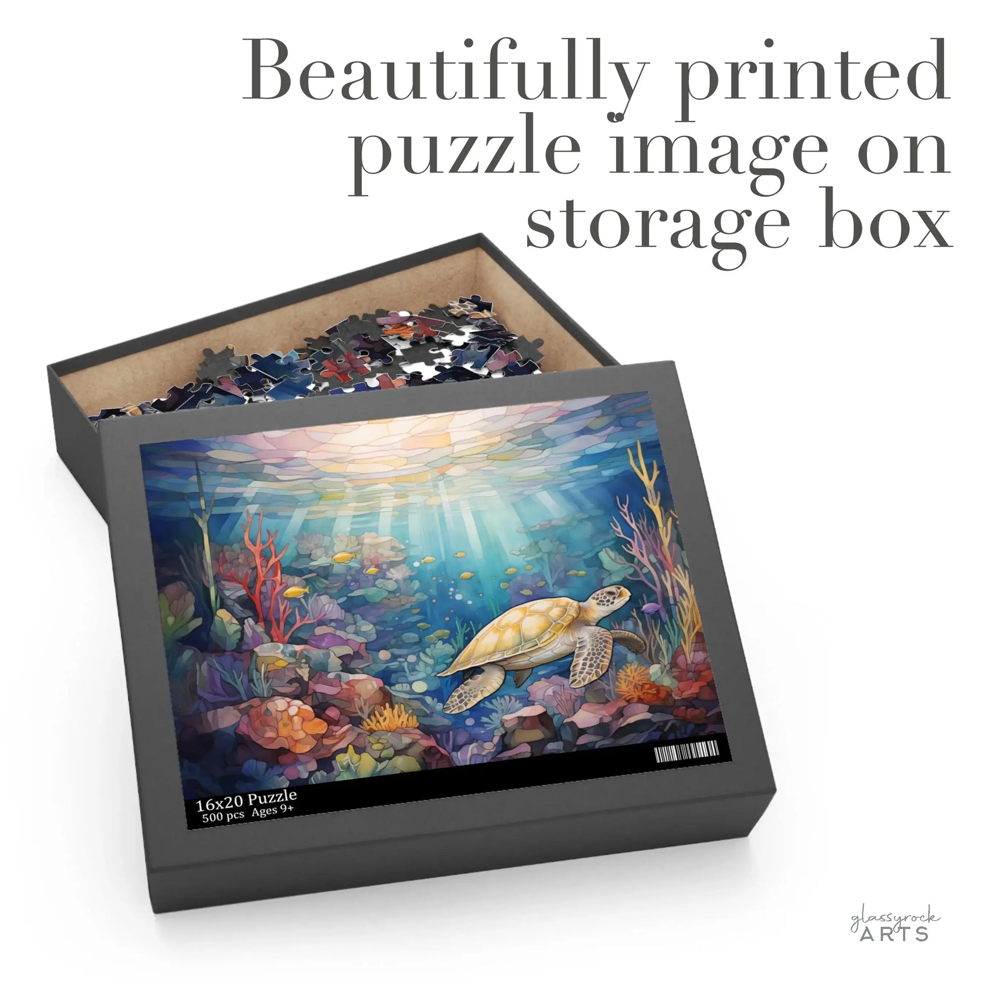 The open Sea Turtle Reef Jigsaw Puzzle box reveals pieces inside. The cover displays a stunning sea turtle swimming through a vibrant reef of coral and fish, with the text Beautifully printed puzzle image on storage box. It makes a perfect stained glass gift for any puzzle enthusiast!.
