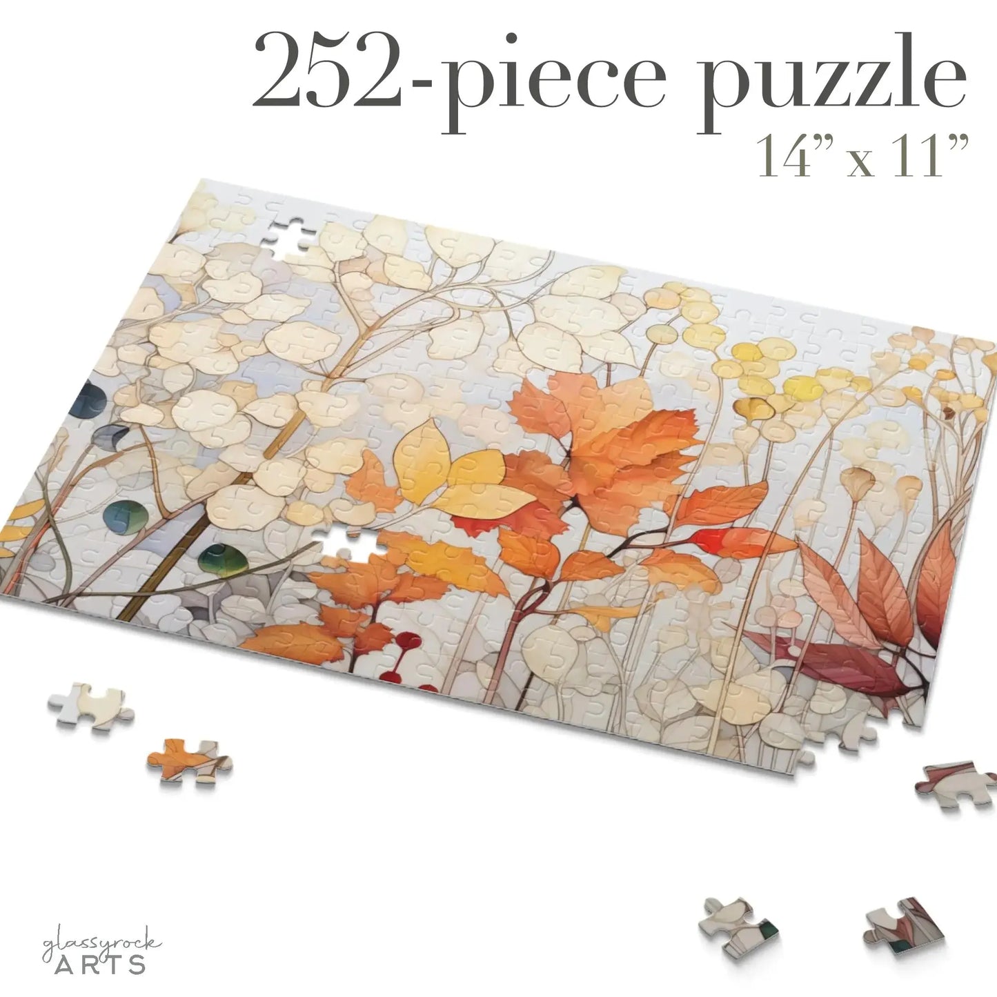 A 252-piece Winter Botanicals Jigsaw Puzzle partially completed, featuring a stained-glass-inspired design with red, orange, and yellow autumn leaves. Scattered pieces surround the 14 x 11 puzzle.