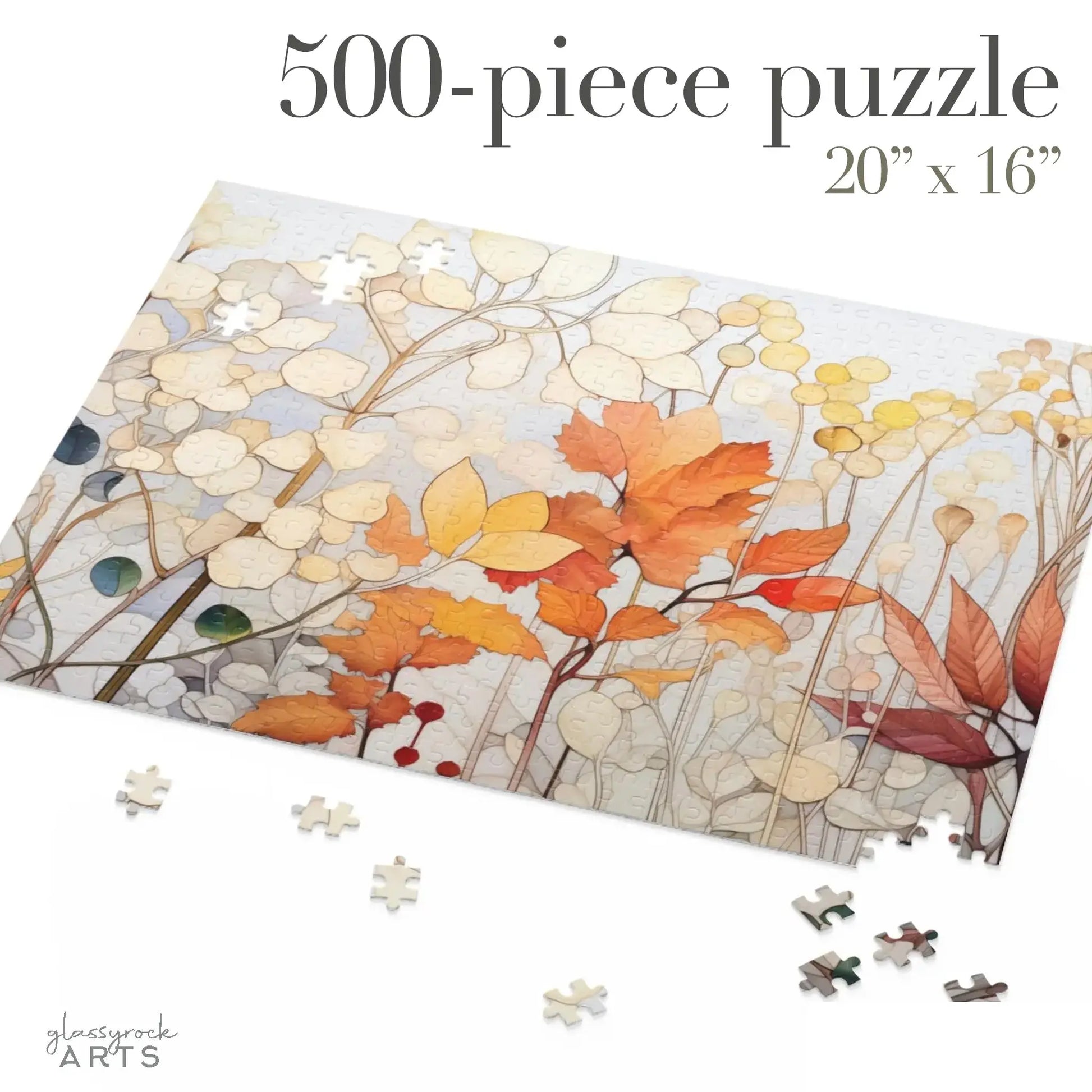 The Winter Botanicals 500-piece puzzle, measuring 20 x 16, features stained glass-inspired autumn leaves in warm colors. It is partially assembled on a white surface with scattered pieces around.