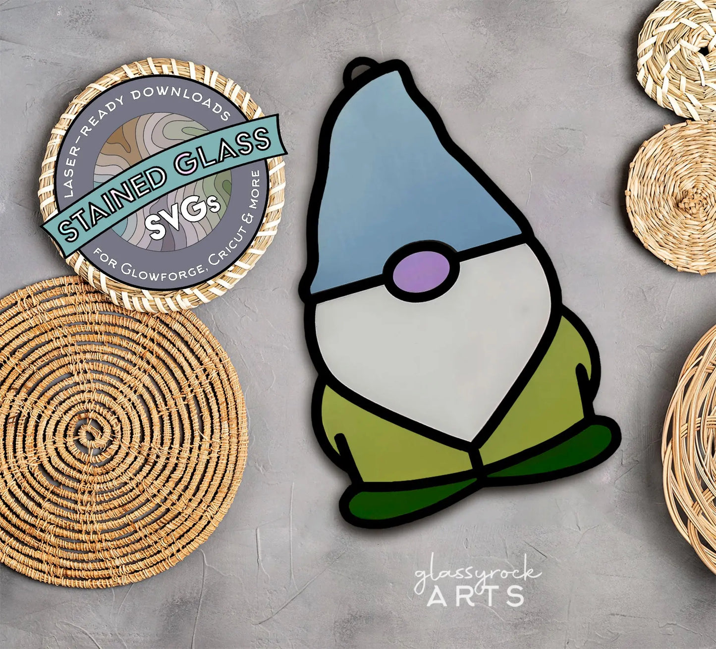 A stained glass style illustration of a garden gnome with a blue hat, pink nose, and green outfit. Accompanied by woven baskets and a circular Laser Ready Downloads Stained Glass SVGs logo. Ideal as an SVG laser cut file for the glassyrock ARTS brand. Background is light gray. Product: Stained Glass Gnome SVGs.