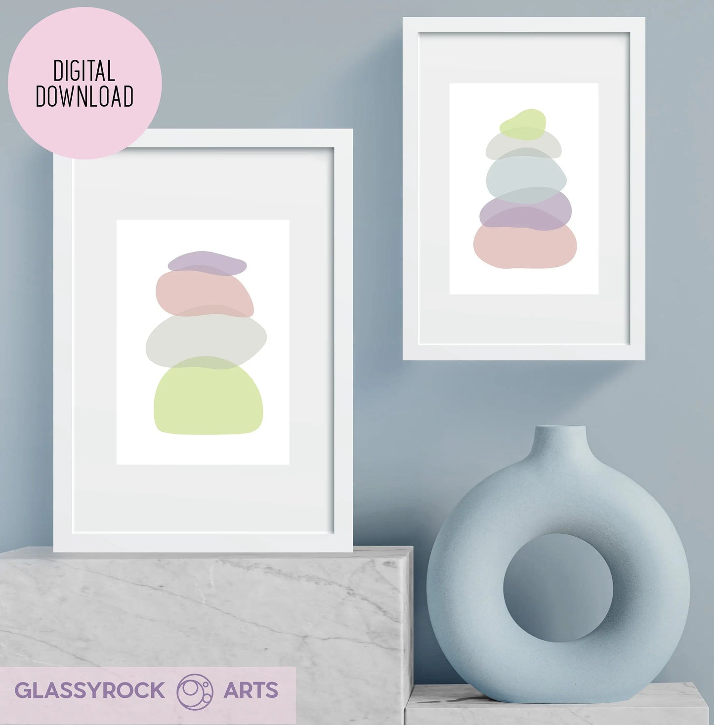 Two minimalist prints titled Pastel Clear Modern Stone Shapes Digital Art hang on a pale blue wall above a light gray surface, next to a round vase. Labeled Digital Download, they add boho flair, while the logo Glassyrock Arts is at the top left corner.