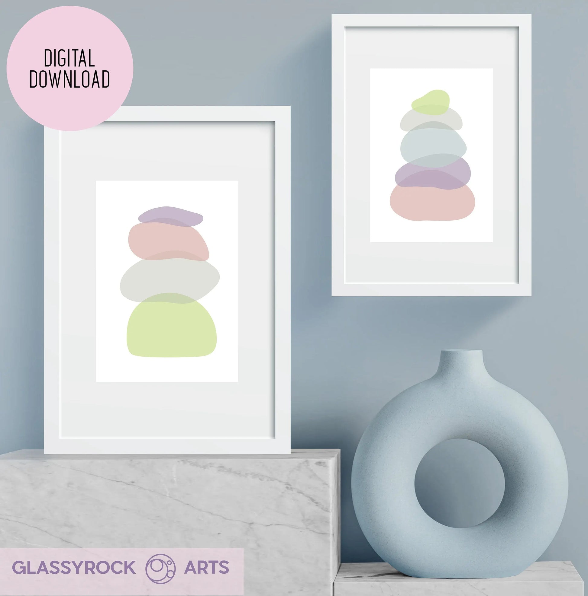 Two minimalist prints titled Pastel Clear Modern Stone Shapes Digital Art hang on a pale blue wall above a light gray surface, next to a round vase. Labeled Digital Download, they add boho flair, while the logo Glassyrock Arts is at the top left corner.