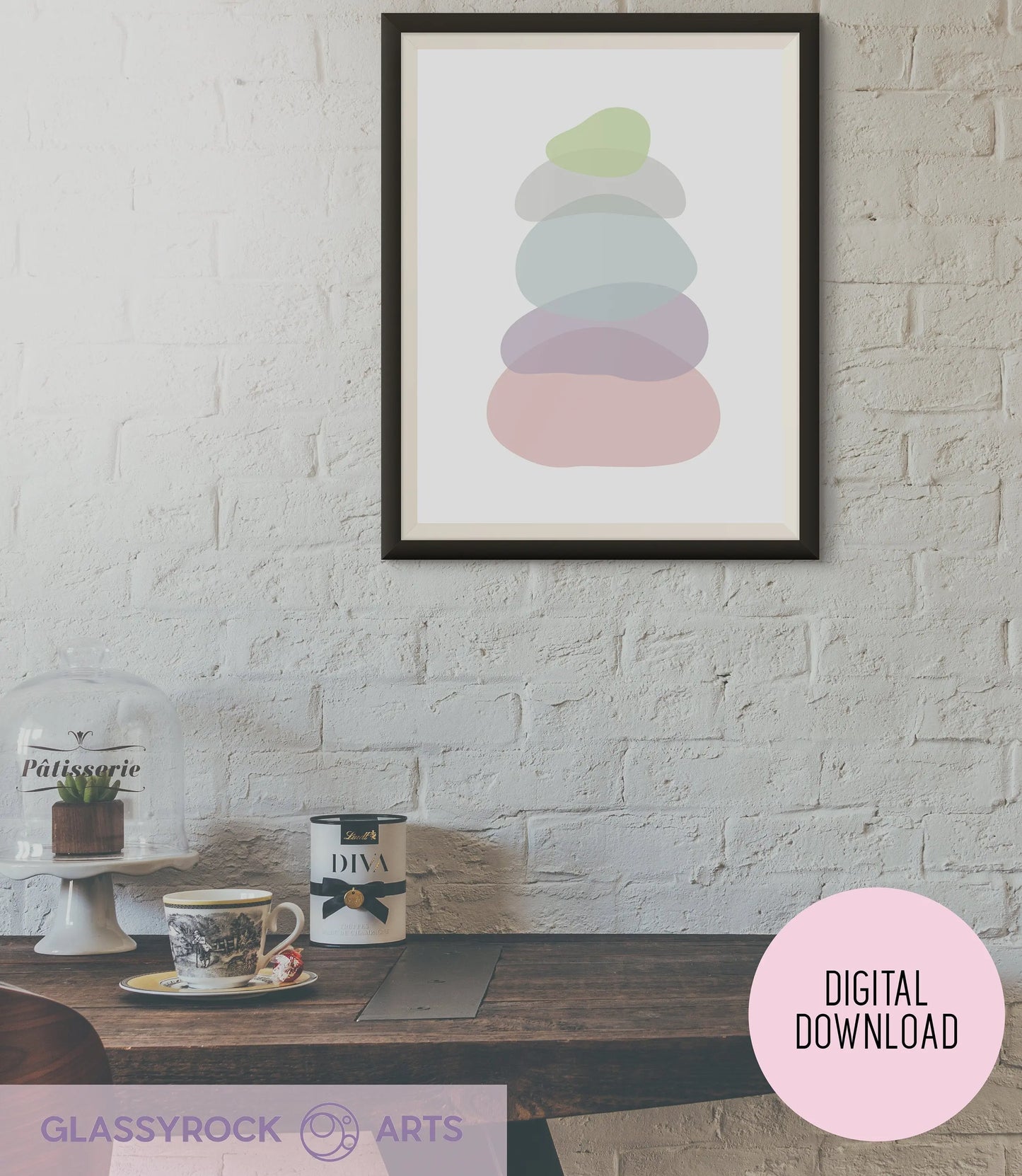 A cozy dining area showcases a wooden table with a cup, saucer, and teapot. The boho décor is enhanced by the Pastel Clear Modern Stone Shapes Digital Art featuring pastel shapes on a white brick wall. A cake stand with a small plant sits on the left. The image is labeled Digital Download.
