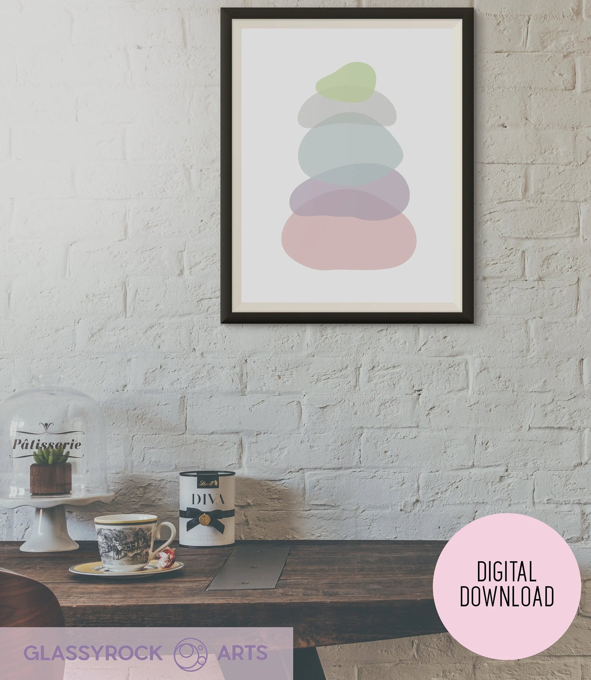 A cozy dining area showcases a wooden table with a cup, saucer, and teapot. The boho décor is enhanced by the Pastel Clear Modern Stone Shapes Digital Art featuring pastel shapes on a white brick wall. A cake stand with a small plant sits on the left. The image is labeled Digital Download.