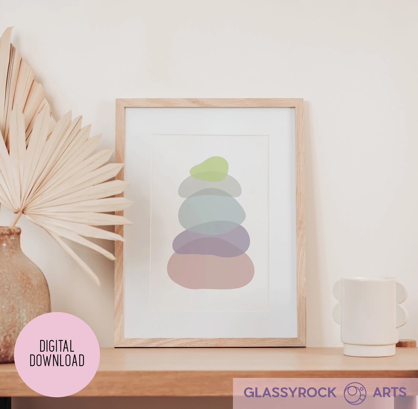 The Pastel Clear Modern Stone Shapes Digital Art framed print on a minimalist wooden shelf complements a vase with dried palm leaves and a white, round-handle mug. A pink circle reads Digital Download, and the bottom showcases the Glassyrock Arts logo, perfect for enhancing boho décor.