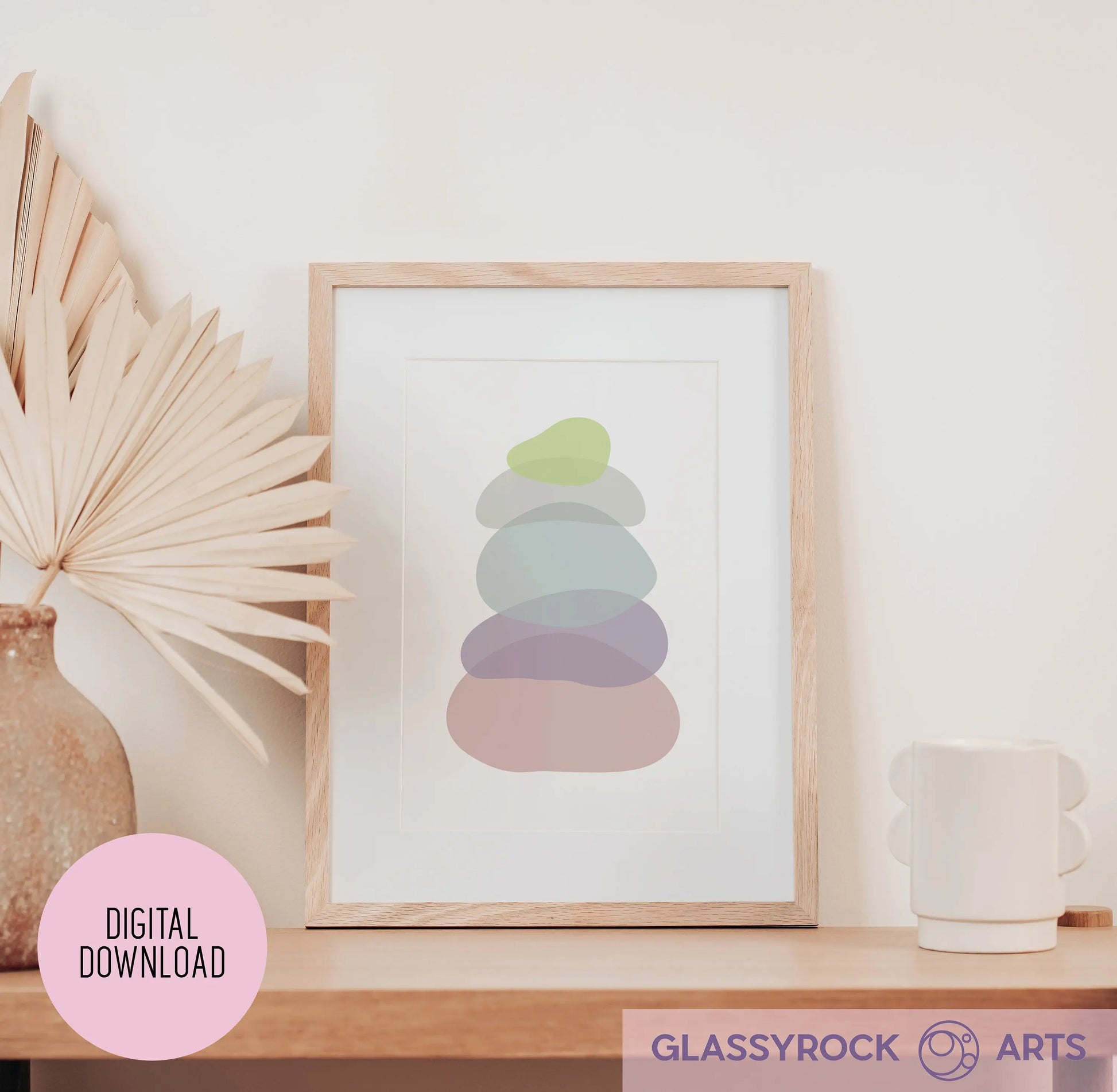 The Pastel Clear Modern Stone Shapes Digital Art framed print on a minimalist wooden shelf complements a vase with dried palm leaves and a white, round-handle mug. A pink circle reads Digital Download, and the bottom showcases the Glassyrock Arts logo, perfect for enhancing boho décor.