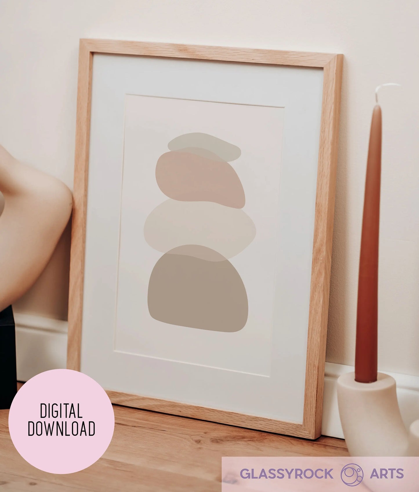 The Ombre Nude Stone Shapes digital artwork leans against a beige wall, paired with a tall brown candle. It features neutral tones and abstract designs, marked with Digital Download and Glassyrock Arts, ideal for fans of digital art printables.
