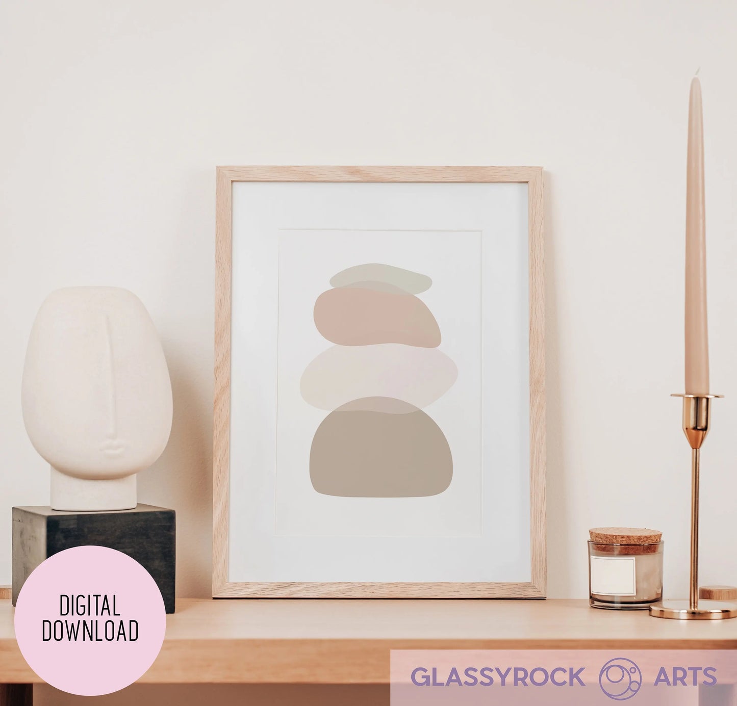 On a shelf, an Ombre Nude Stone Shapes art print in a wooden frame is displayed alongside a modern ceramic face sculpture, a sleek candle holder with a lit taper candle, and a small candle. Text overlay reads: Instant Digital File and GLASSYROCK ARTS.