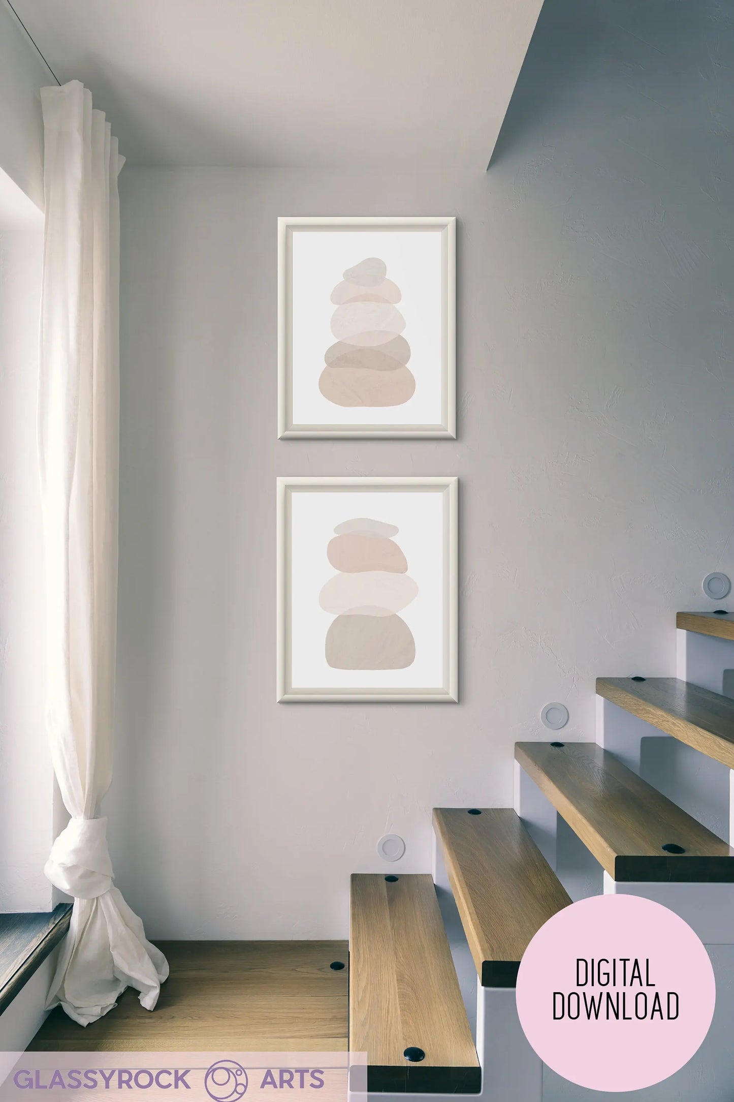 A modern interior showcases a wooden staircase, with two framed Ombre Nude Modern Stone Shapes artworks on the wall. Sheer white curtains partly cover a large window, letting in soft natural light that enhances the boho Japandi Scandi decor.
