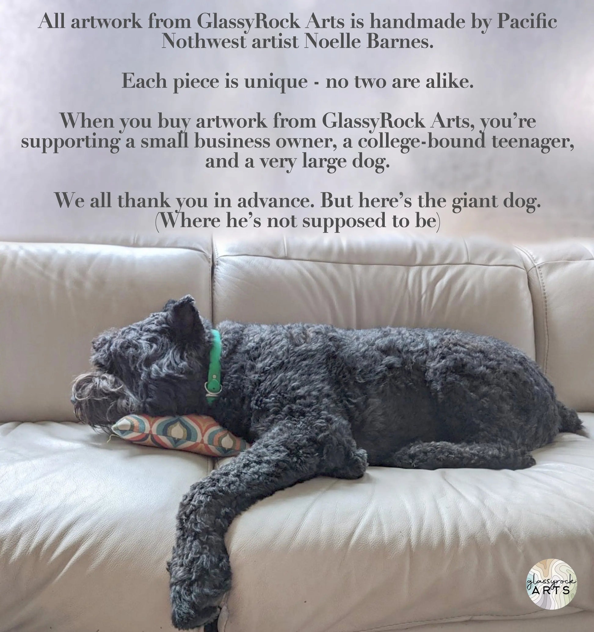 A large, curly-haired dog lounges on a couch with its head on a pillow, wearing a green collar. The background text highlights unique handmade stained glass by Pacific Northwest artist Noelle Barnes, featuring her Handmade Stained Glass Flower Plant Stake with Rose Quartz.