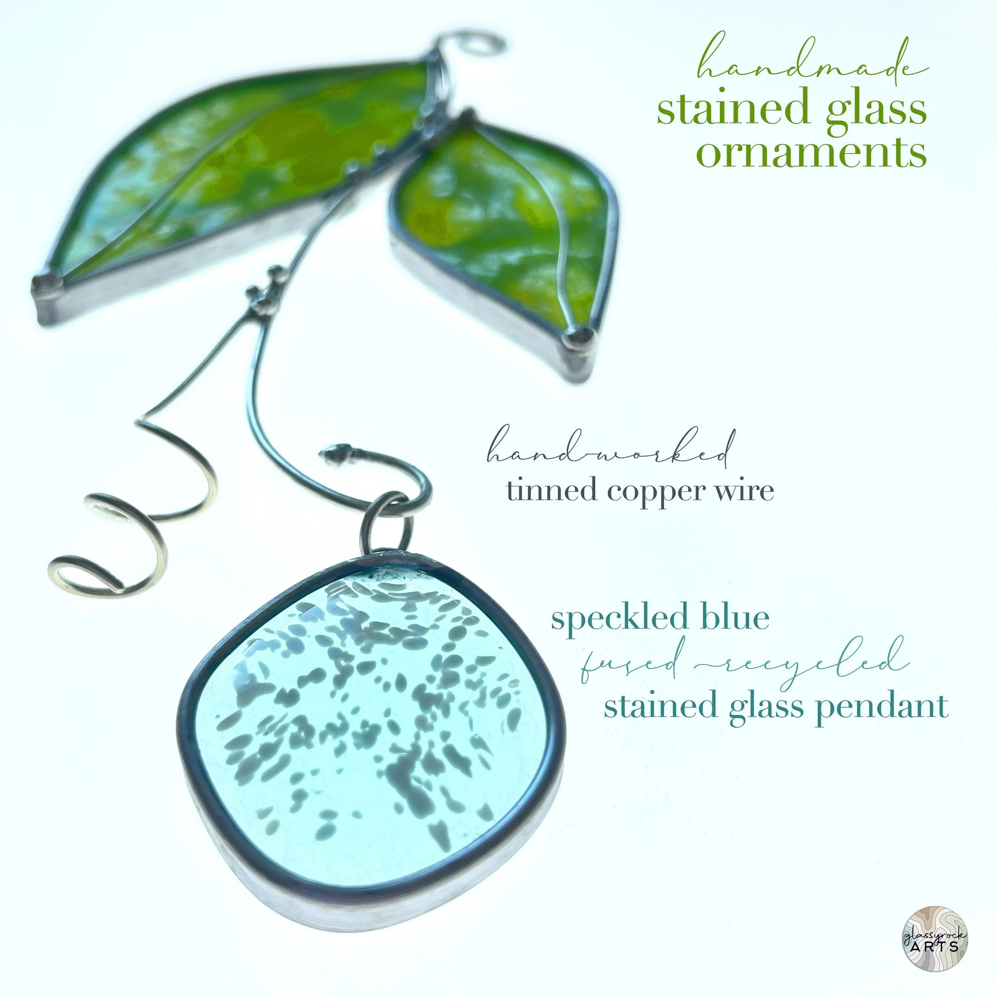 A close-up shows handmade stained glass leaf suncatchers with speckled blue fused recycled glass pendants and tinned copper wire. Green glass leaves enhance the background. Text reads: Handmade Stained Glass Leaf Suncatchers.