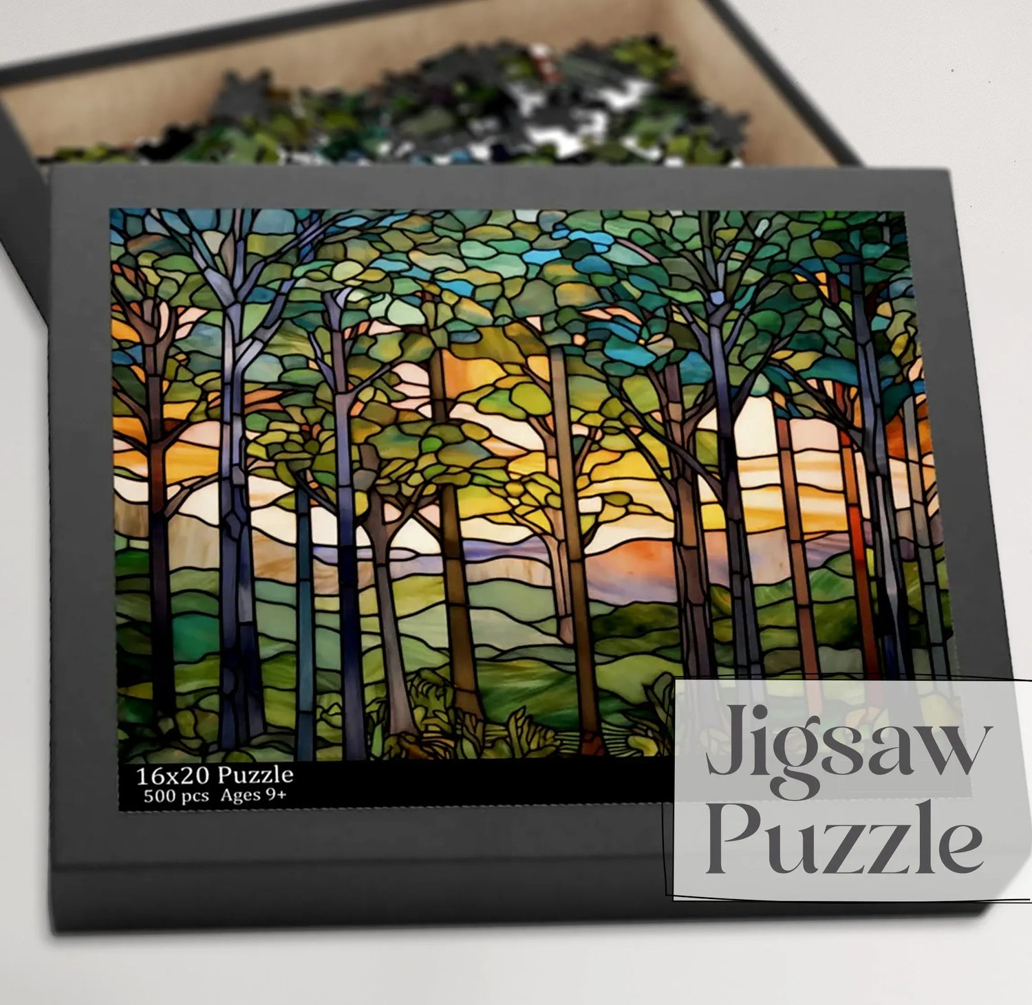 Box of a jigsaw puzzle featuring a stained glass forest scene with trees and a sunset on the cover. Box indicates 500 pieces, suitable for ages 9 and up.