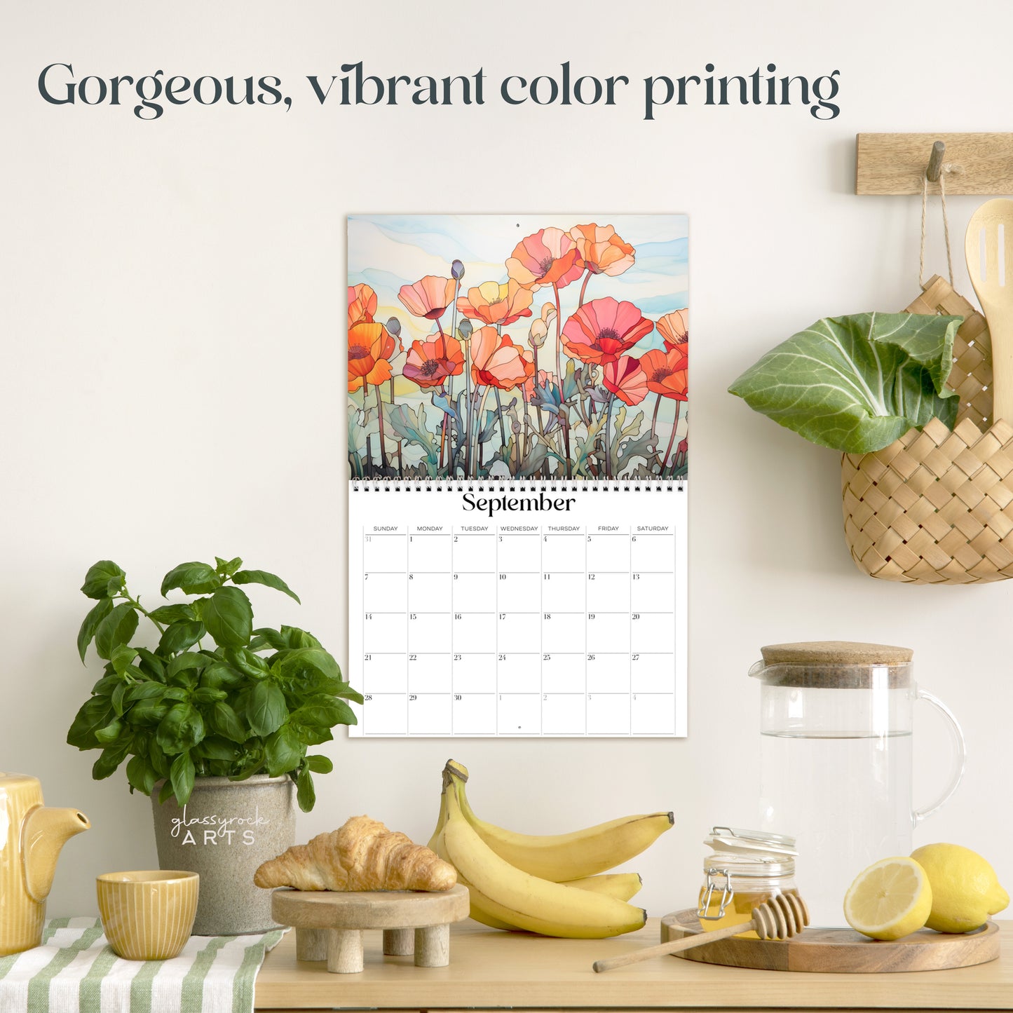 The poppies calendar hanging in a kitchen with kitchen tools below on a counter. It has gorgeous, vibrant color printing on premium paper.