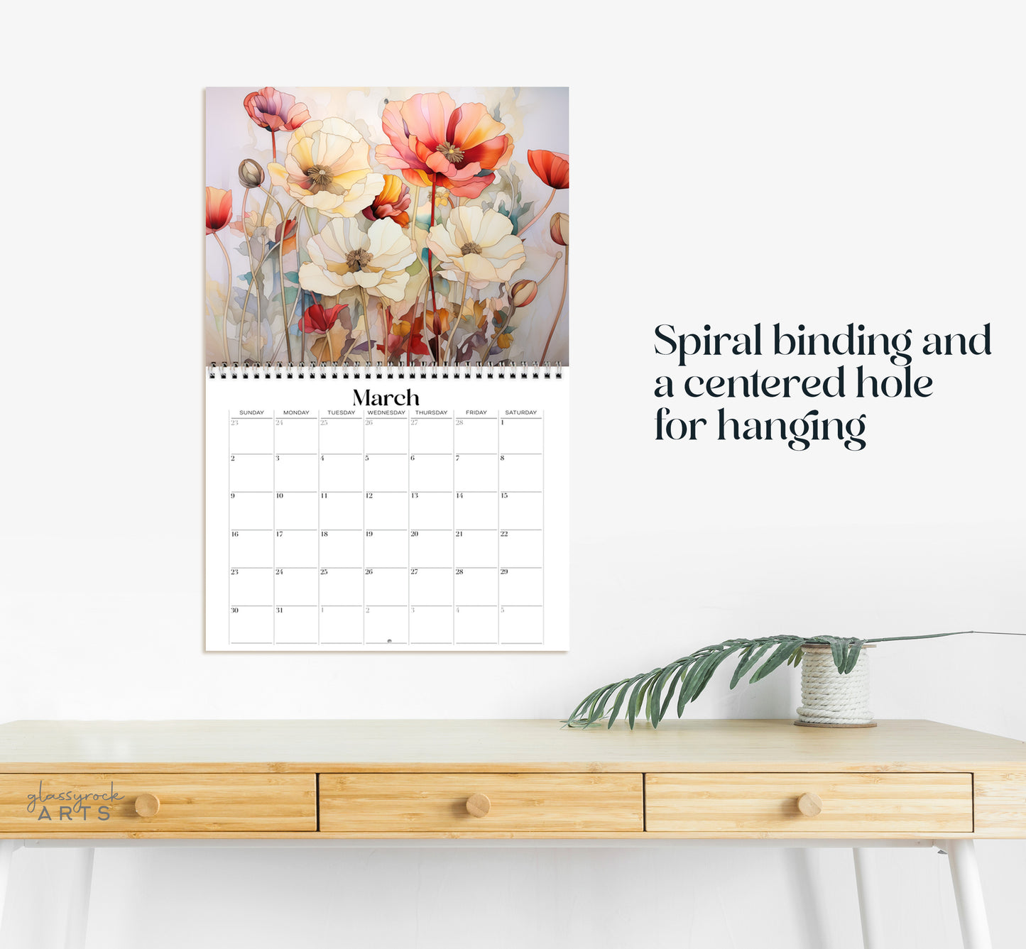 This calendar has a spiral binding and a centered hole for hanging.