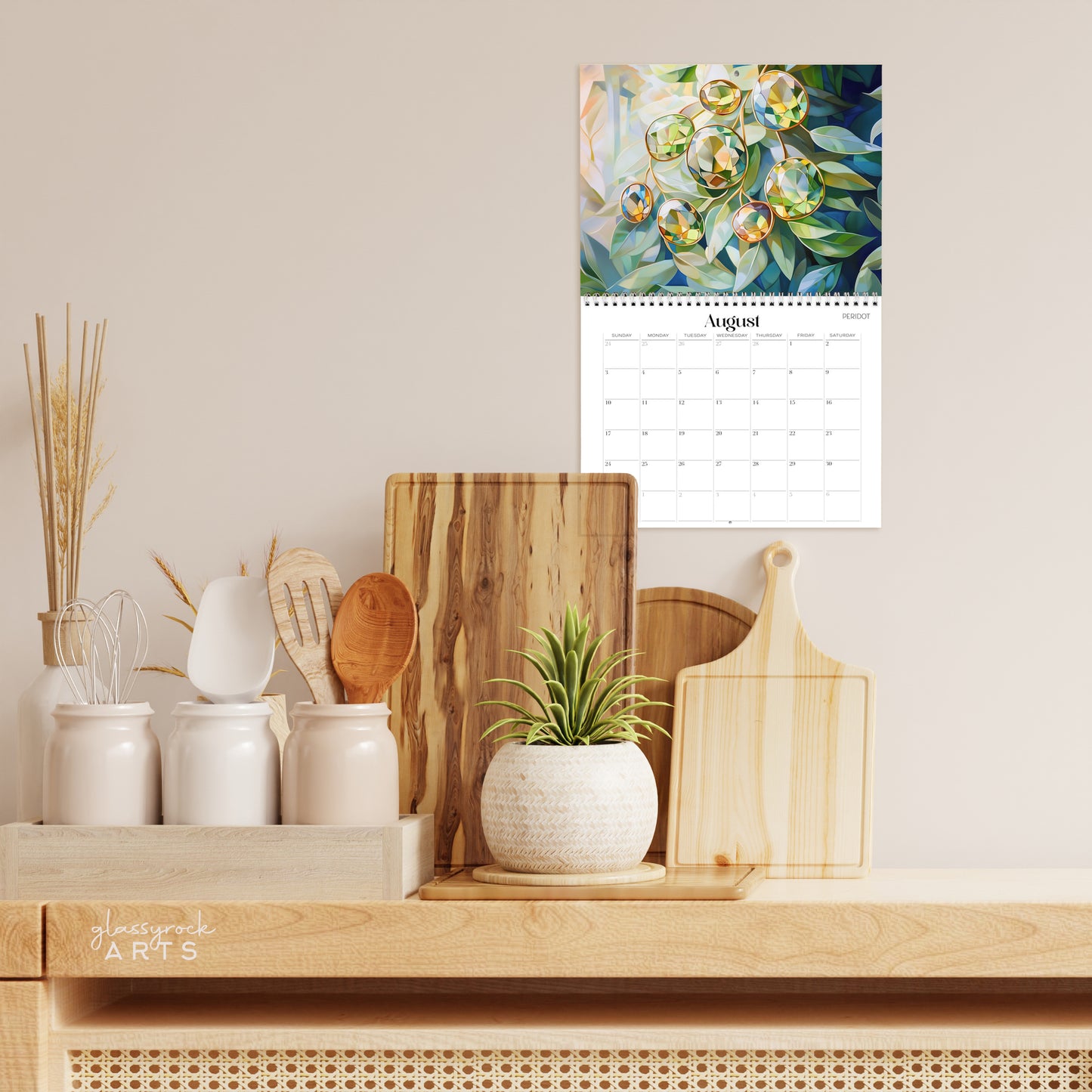 The poppies calendar hanging on a wall above a kitchen counter.