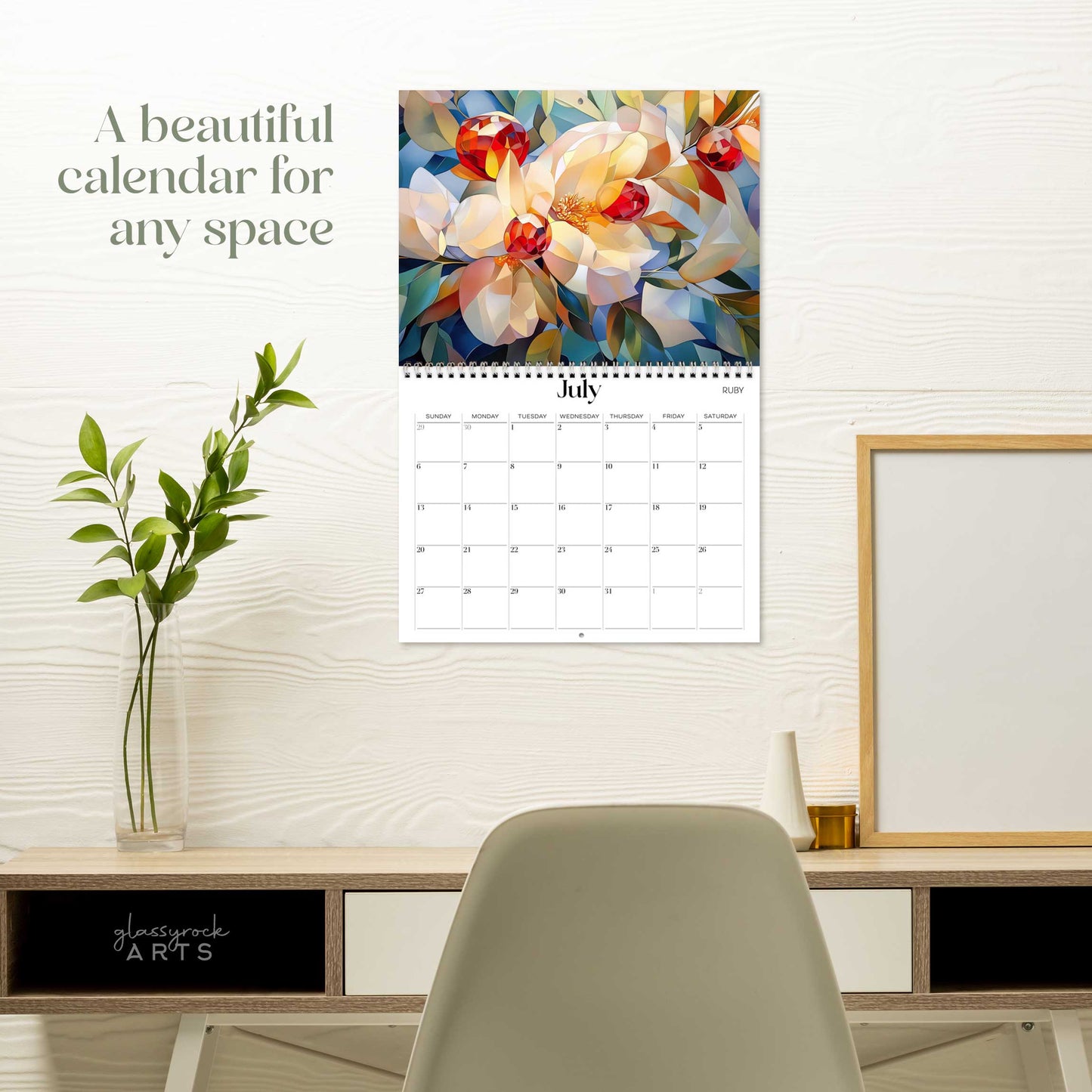 The birthstones calendar hanging on a white wall over a desk. The text reads "a beautiful calendar for any space."