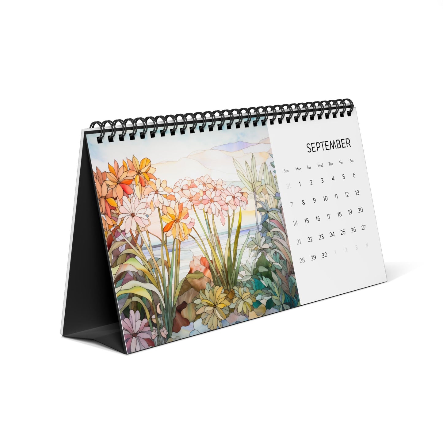 The 2025 Desk Calendar - Tropical Flowers, open to September, showcases a stunning illustration of colorful flowers and foliage on the left, reminiscent of stained glass art. Proudly made in the USA.