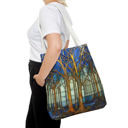 A person carrying the Stained Glass Blue Forest Tote Bag with white straps features a vibrant forest design with gold trees against a blue and white background. Crafted from durable polyester, this stylish and sturdy tote bag is perfect for your daily errands and comes in three different sizes.