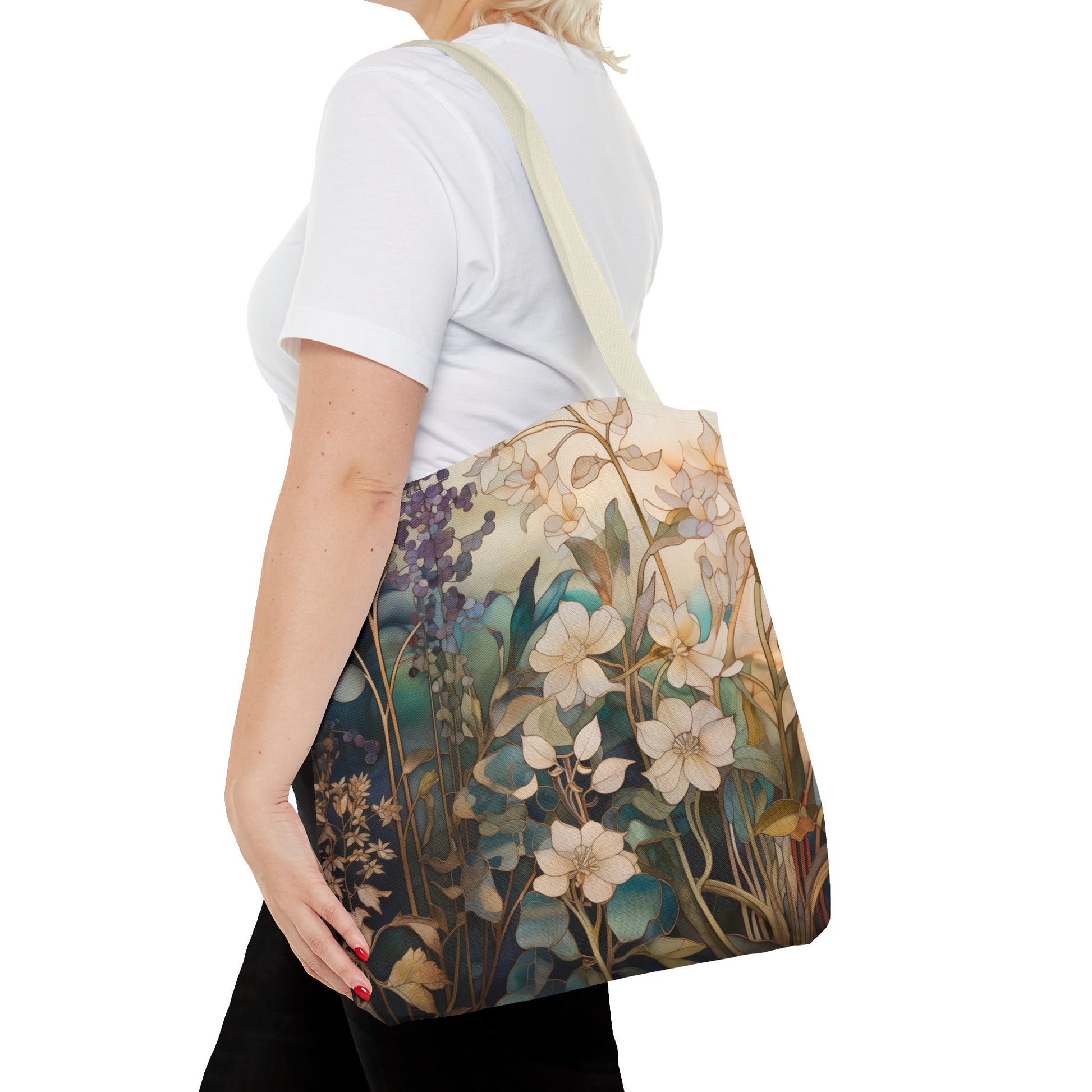 A person wearing a white shirt carries the Stained Glass Midnight Flowers Tote Bag, made of durable polyester and featuring a floral design with various flowers.