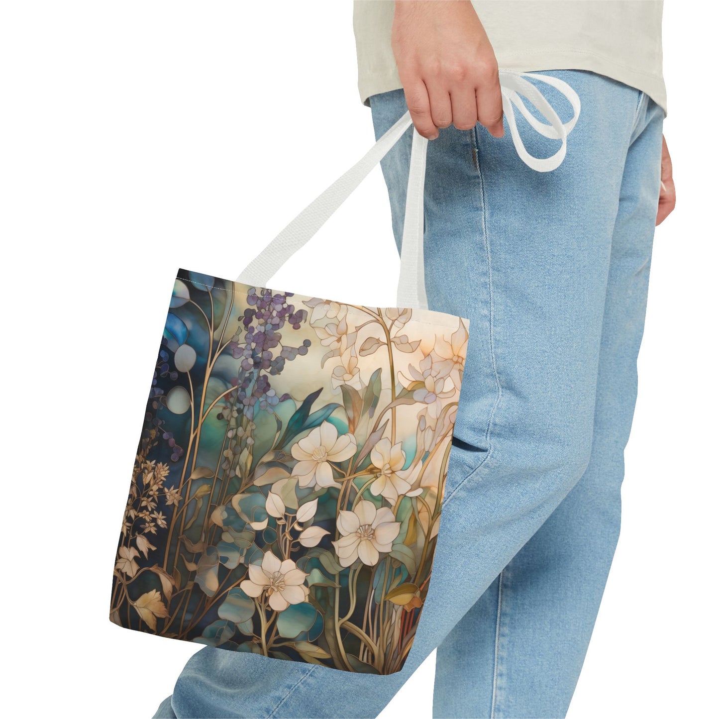 The person carries a Stained Glass Midnight Flowers Tote Bag, beautifully contrasting their light denim jeans and pale shirt. The durable polyester ensures longevity, while the plain white background highlights the totes charm. Available in 3 sizes.