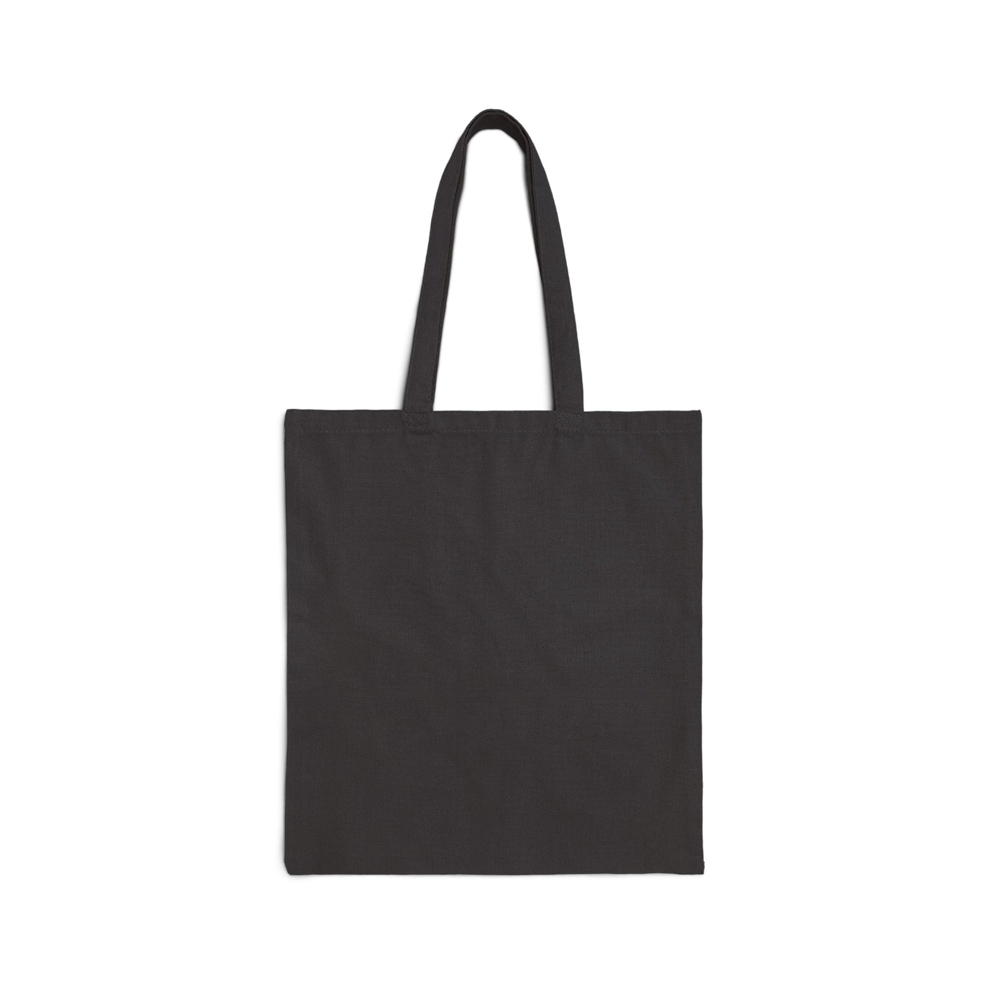 A Stained Glass Cactus Teardrop Cotton Canvas Tote Bag, black and square-shaped with two long handles, is displayed against a white background. The bag seems to be made of fabric and showcases an original artwork reminiscent of a stained glass design.