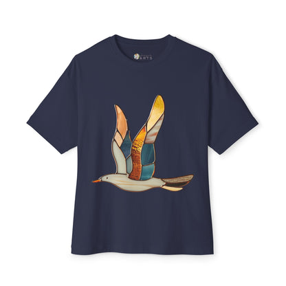 A navy blue Stained Glass Seagull Oversized T-shirt by Bella+Canvas, featuring a colorful stained glass illustration of a seagull in flight on the front, made with sustainable materials.