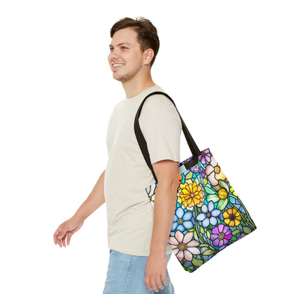 A person in a light beige t-shirt and blue jeans smiles while carrying a Stained Glass Folk Art Flowers Tote Bag, featuring an original floral design on durable polyester.