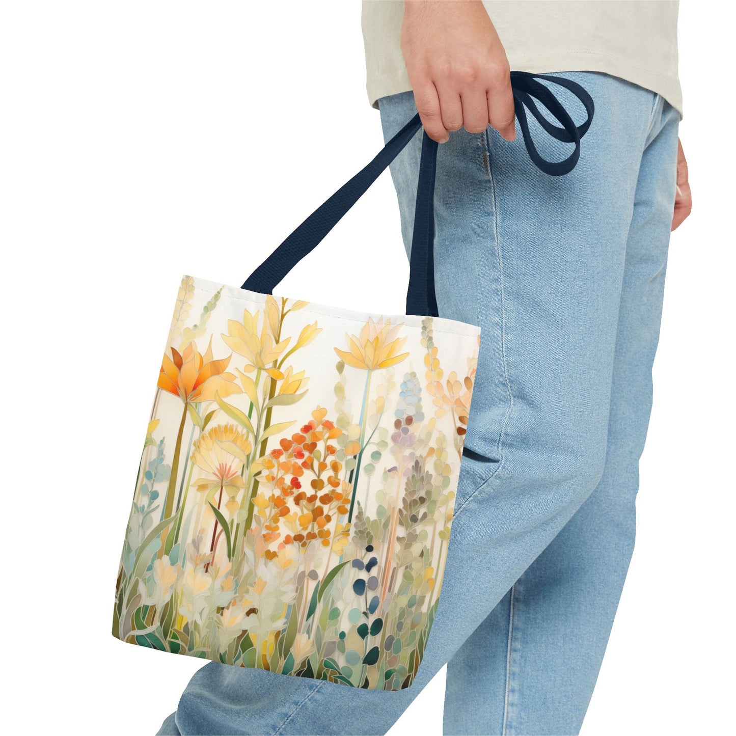 The Stained Glass Fall Flowers Tote Bag, available in 3 sizes, has handles and is crafted from durable polyester materials. It features an original artist's illustrated pattern of colorful wildflowers in shades of orange, yellow, and light blue set against a white background, evoking the beauty and intricacy of stained glass art.