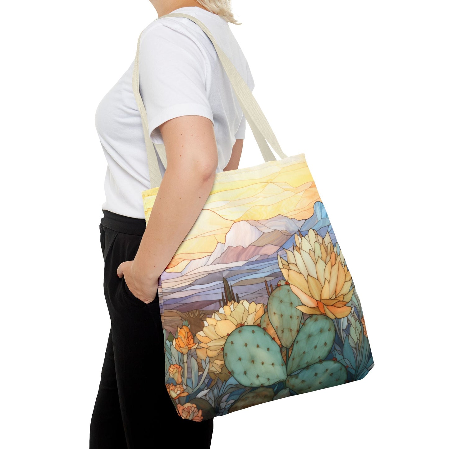 The Stained Glass Desert Cactus Tote Bag, crafted from durable polyester, showcases a nature-themed design with a botanical desert illustration of a landscape with succulents and cactus.