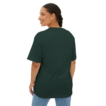 A person with braided hair is shown from the back wearing a dark green Stained Glass Turtle Oversized Tee Shirt and light blue jeans.