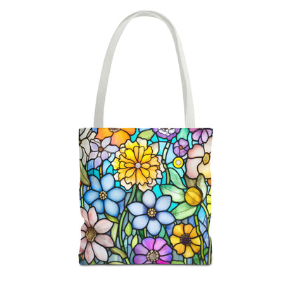 The Stained Glass Folk Art Flowers Tote Bag showcases original art with a vibrant floral pattern in blue, yellow, pink, and purple. Crafted on durable polyester with sturdy white handles, this design mimics stained glass beauty. Available in three sizes.