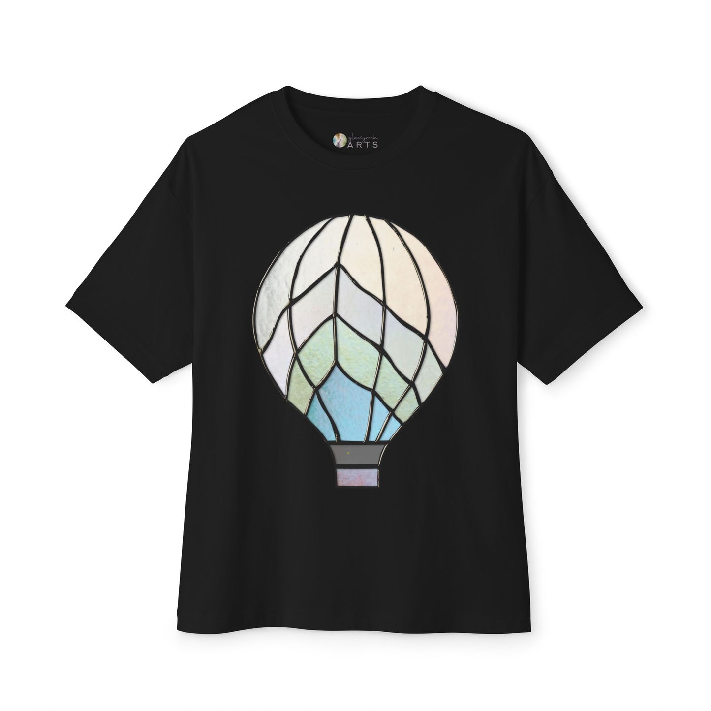 The Stained Glass Hot Air Balloon Oversized Tee Shirt from Bella+Canvas features an art nouveau-style hot air balloon design in pastel colors on the front, giving it a stunning stained glass appeal.