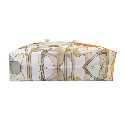 A rectangular fabric pouch with a zipper on top, showcasing interwoven abstract earth tones like brown, beige, and soft green, resembling a stained glass poppy flower with two small white tassels on the zipper. Product: Stained Glass Poppy Flowers Oversized Tote Bag.