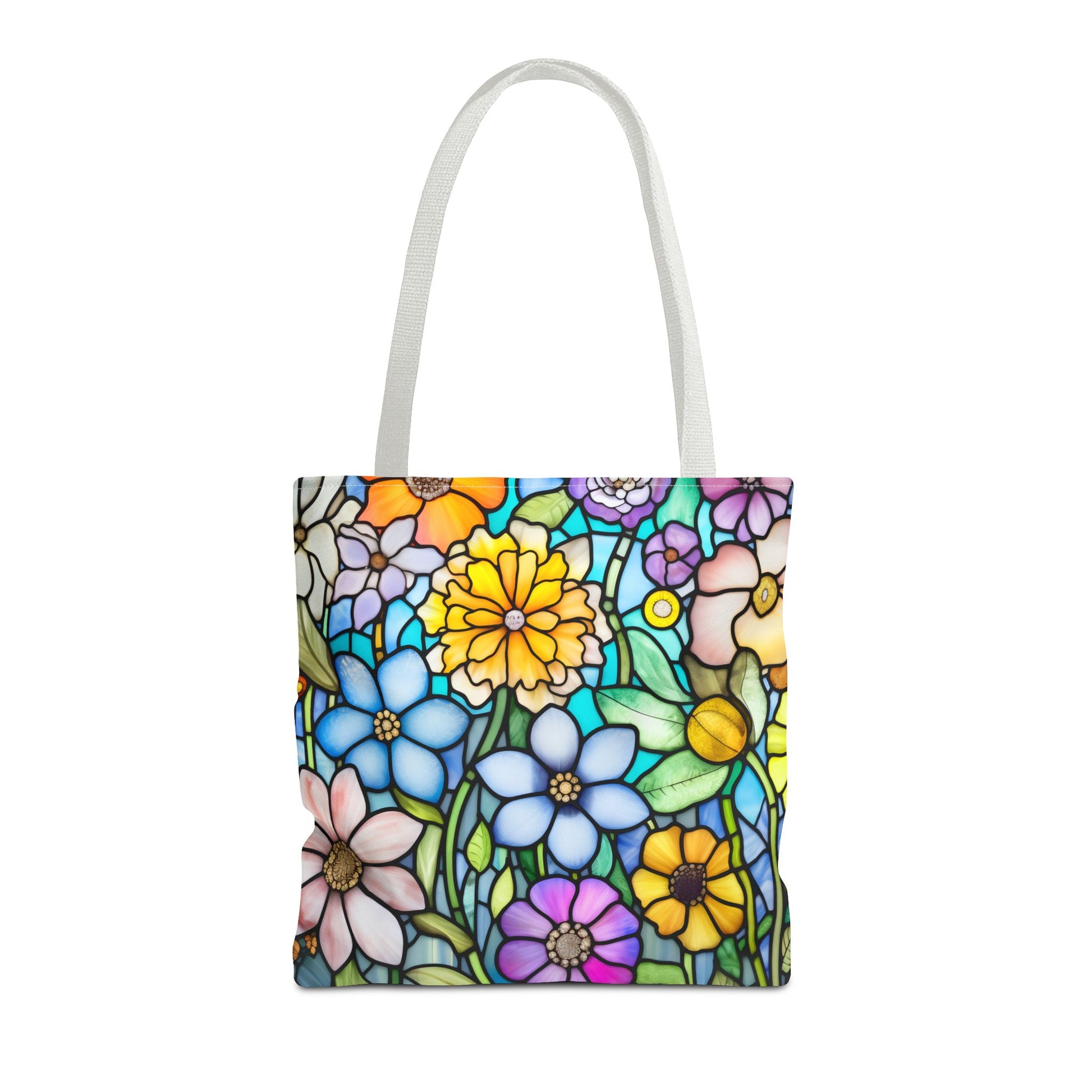 The Stained Glass Folk Art Flowers Tote Bag, available in three sizes, features a colorful stained glass floral design with various flowers in blue, yellow, pink, and green hues. This unique tote bag showcases an original artist design and is made from durable polyester materials.